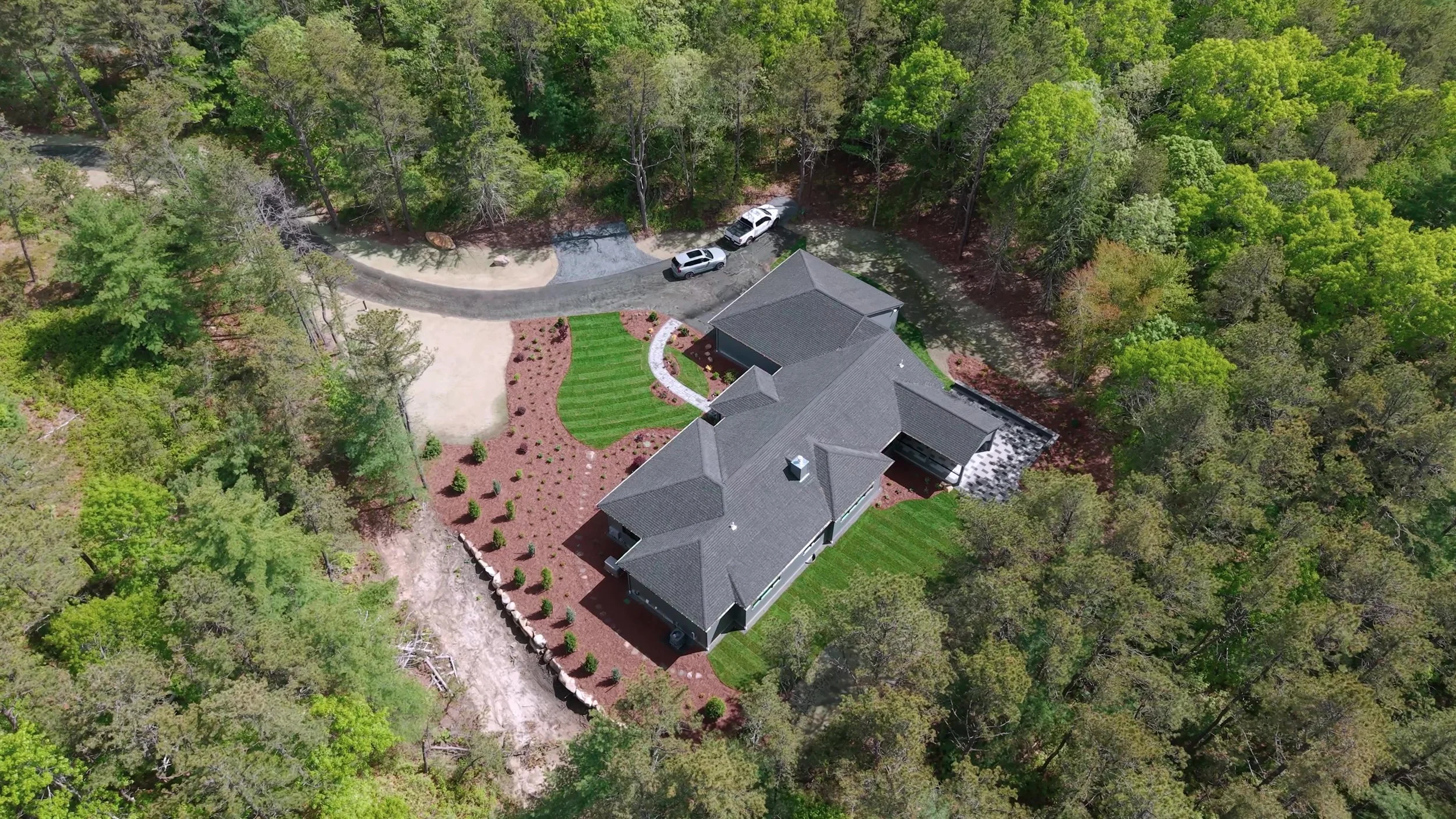 Drone photo of residential project with lawn care, mulching, walkways