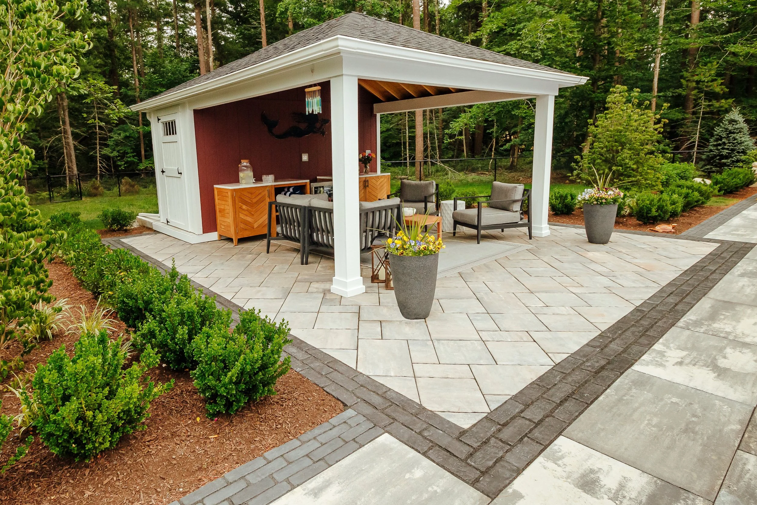 Backyard patio design with seating area in Plymouth, MA