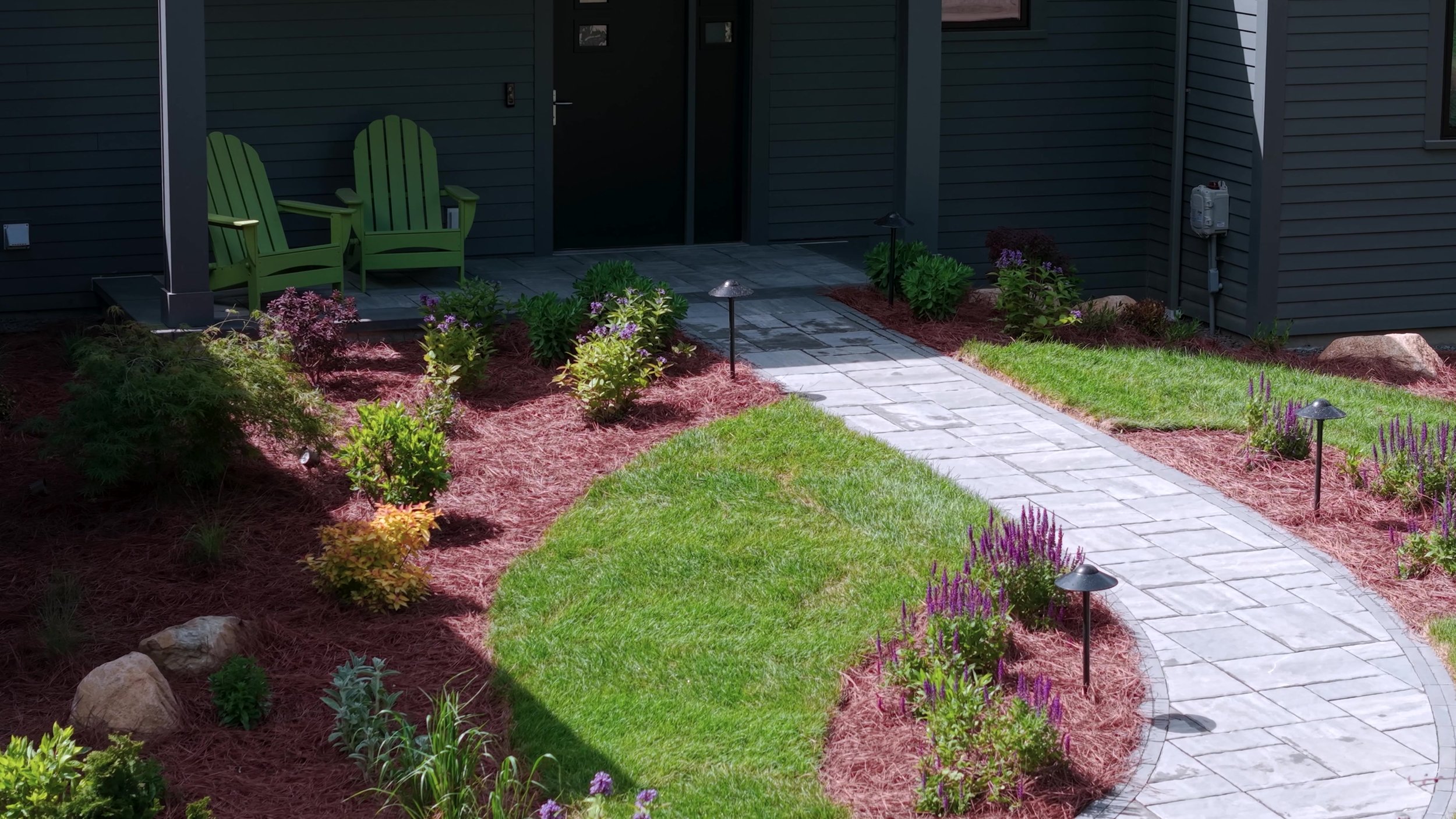 Paver walkway, landscape lighting, and plantings