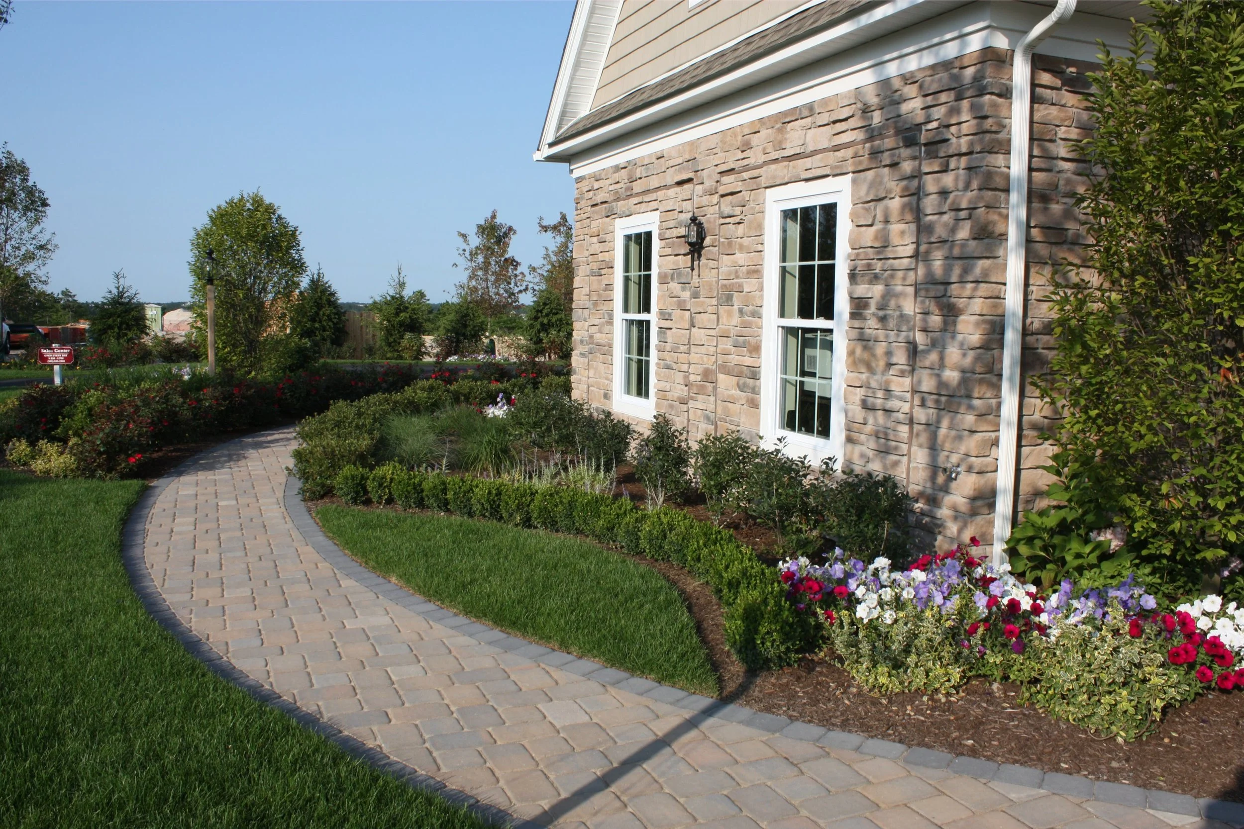 Landscape design with trees and shrubs in Pembroke, MA