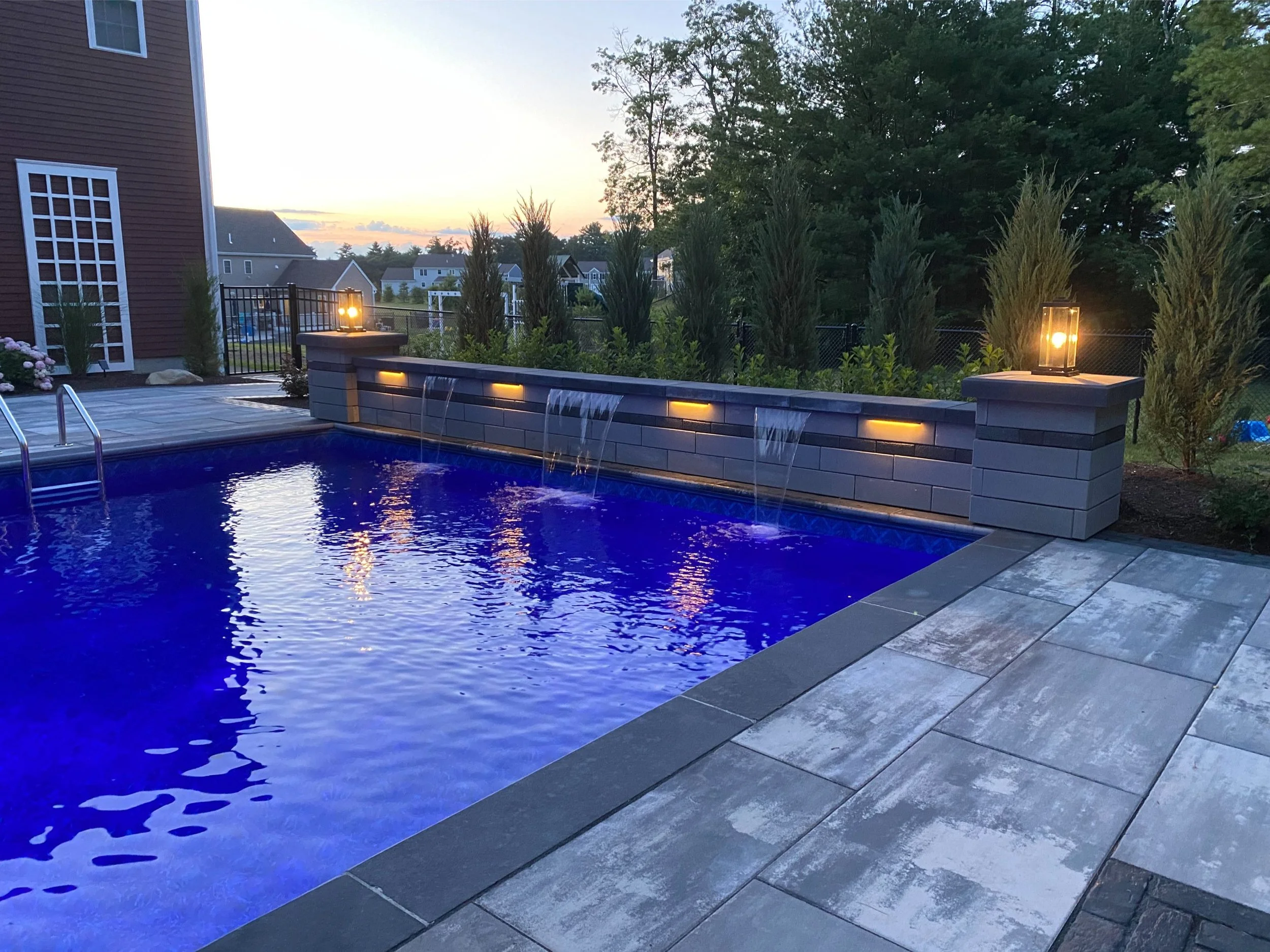 Backyard patio with lighting system in Plymouth, MA
