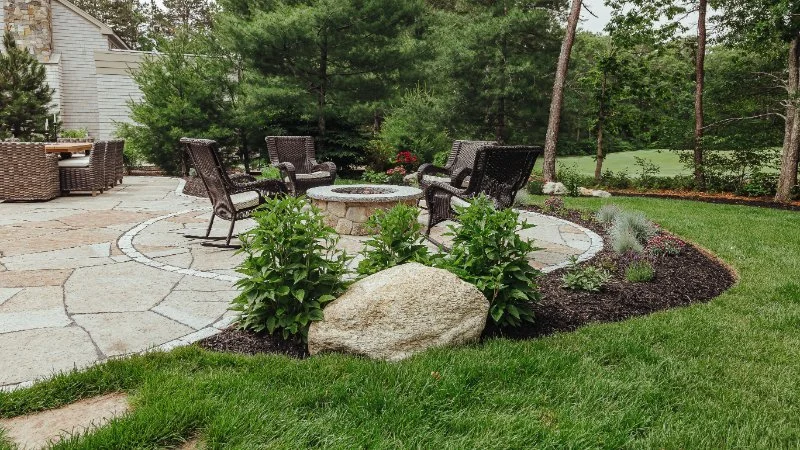 Curving beds and flagstone guide movement through the space