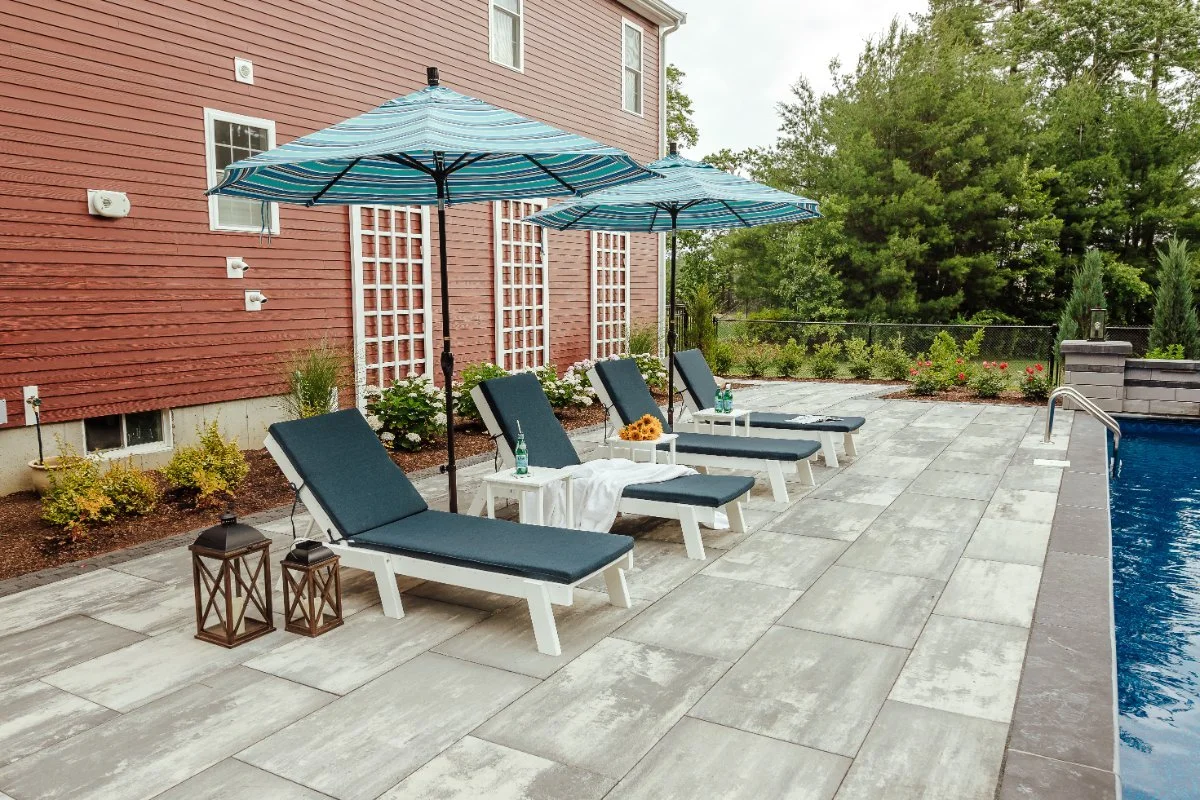 Poolside lounging chairs and umbrellas for backyard relaxing