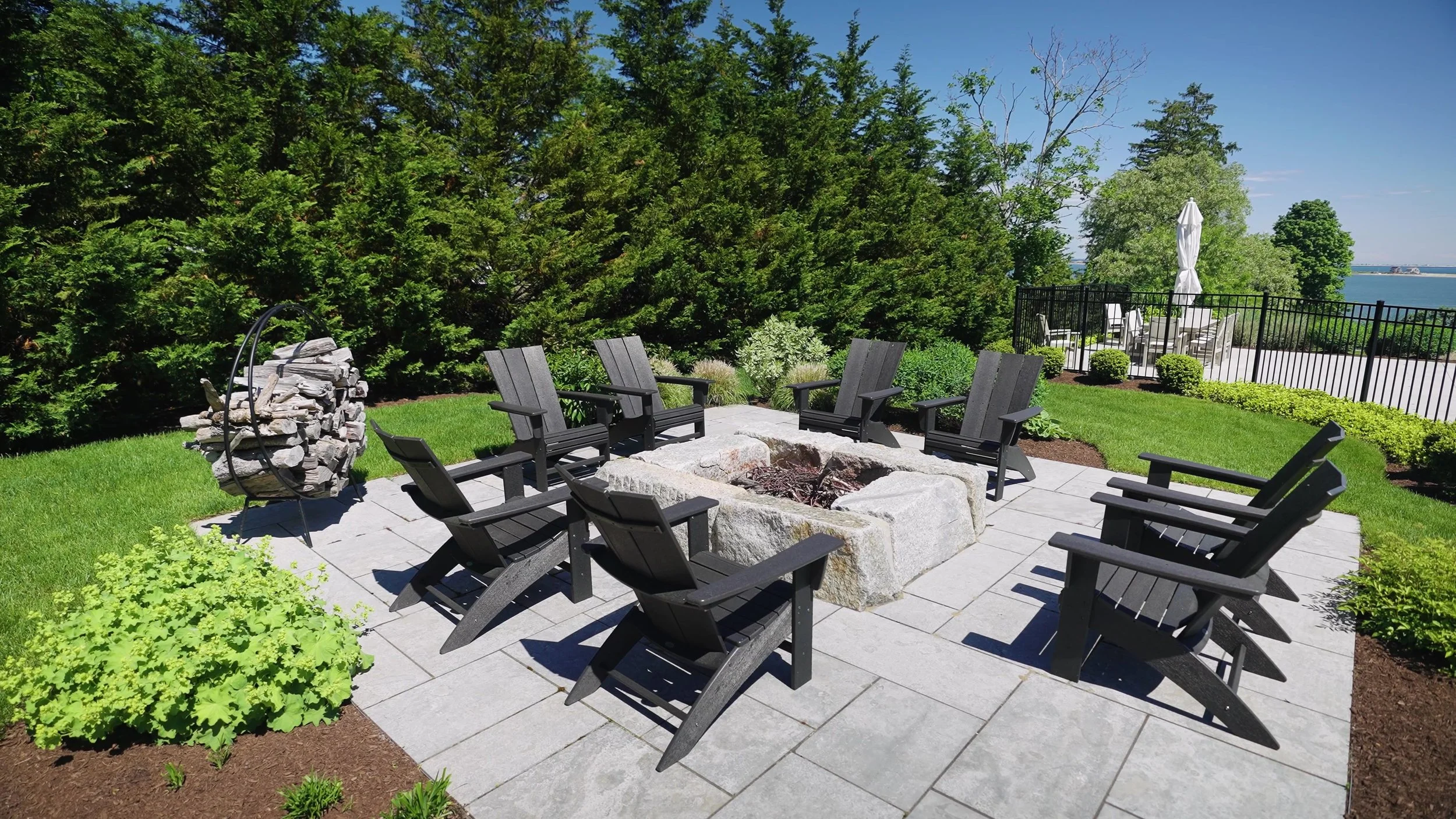Landscape design and fire pit by Greener Horizon