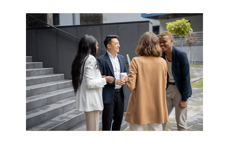 A group of people standing outside enjoying a discussion