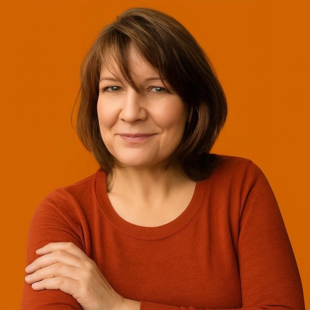A woman with shoulder-length brown hair wearing a rust-colored top against an orange background