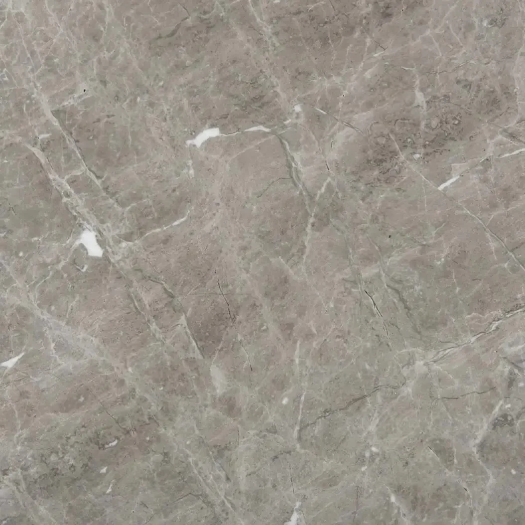 Close-up of a beige marble surface with natural veining and subtle color variations.