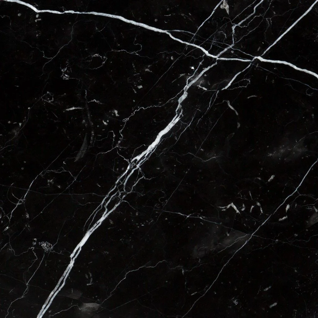 Close-up view of black marble surface with white veining.