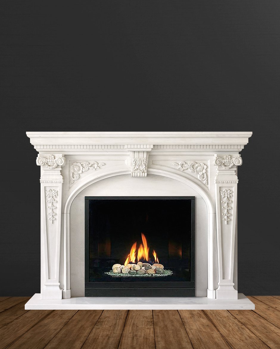 White ornate fireplace with a lit gas or electric fire, set against a dark wall with wooden flooring.