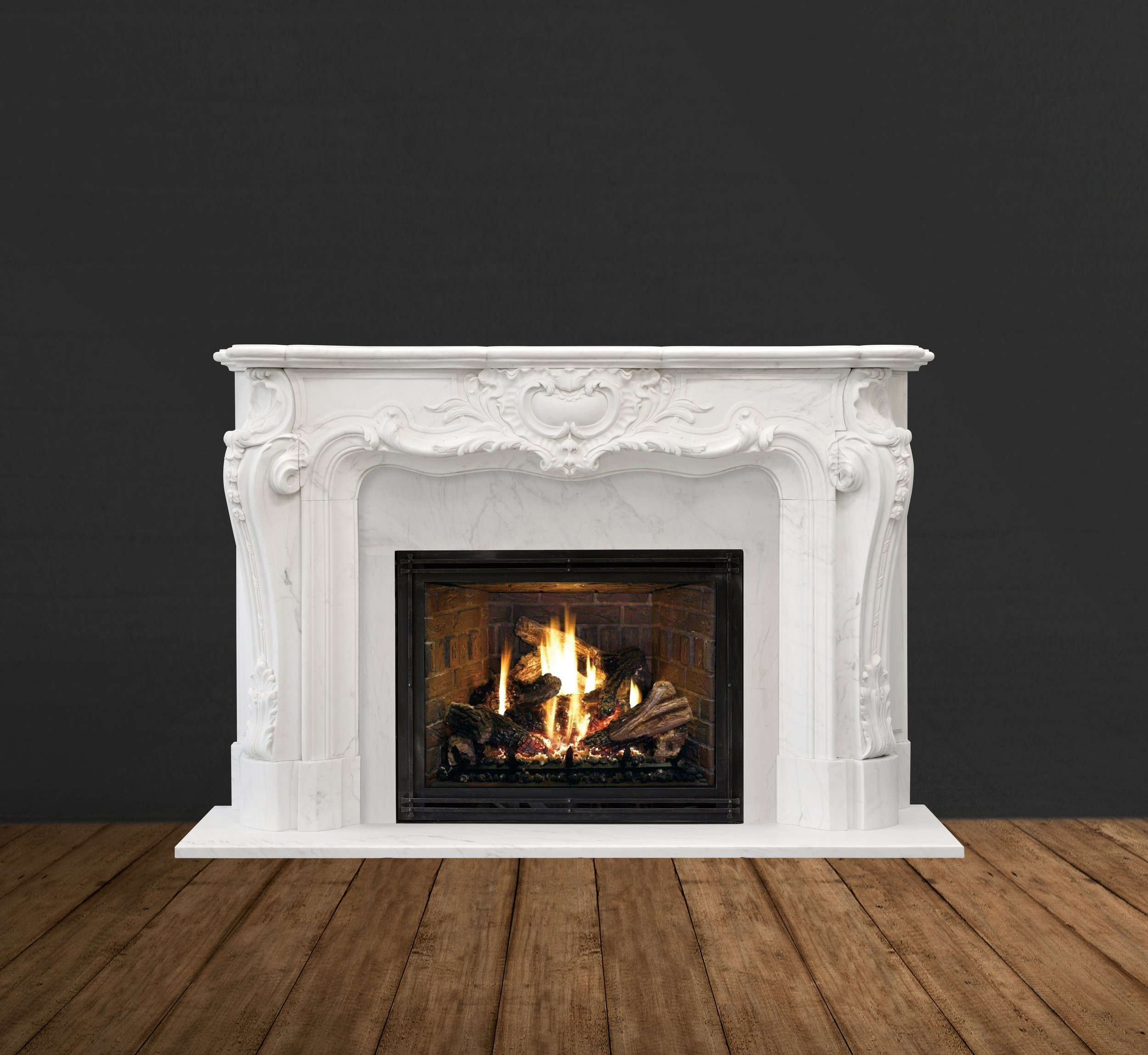 White ornate fireplace with a burning fire set against a dark wall and wooden floor.