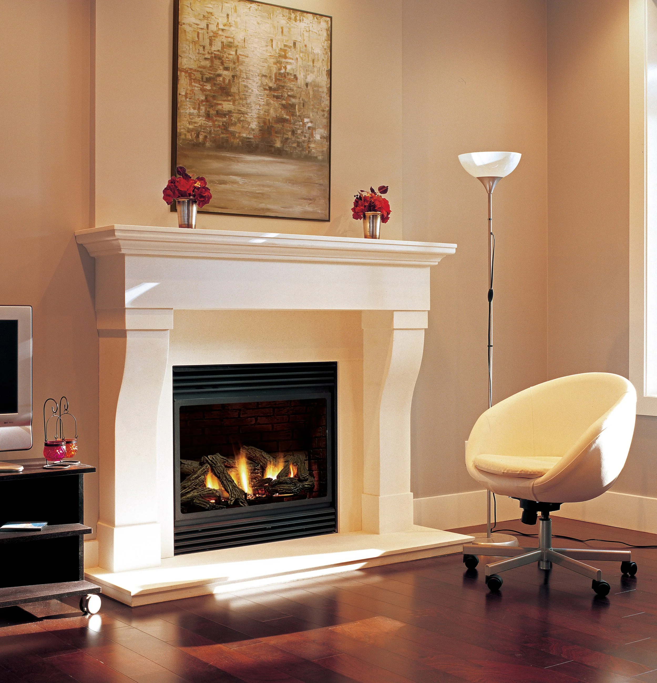 Living room with a white fireplace, lit fire, two vases with red flowers on the mantel, a modern yellow swivel chair, a tall floor lamp, a small TV on a rolling cart, and a window with natural light.