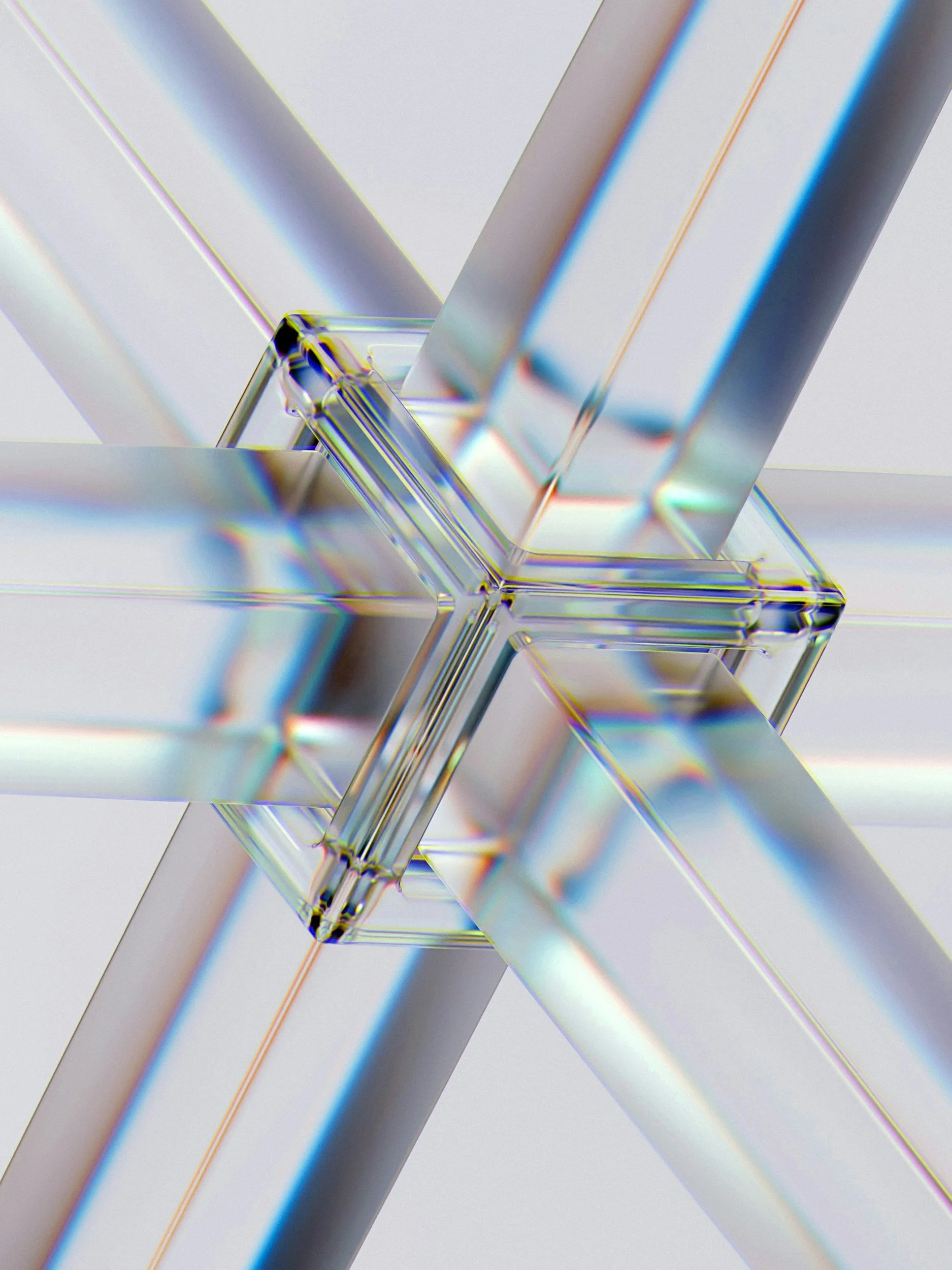Close-up of a glass prism refracting light into rainbow colors.