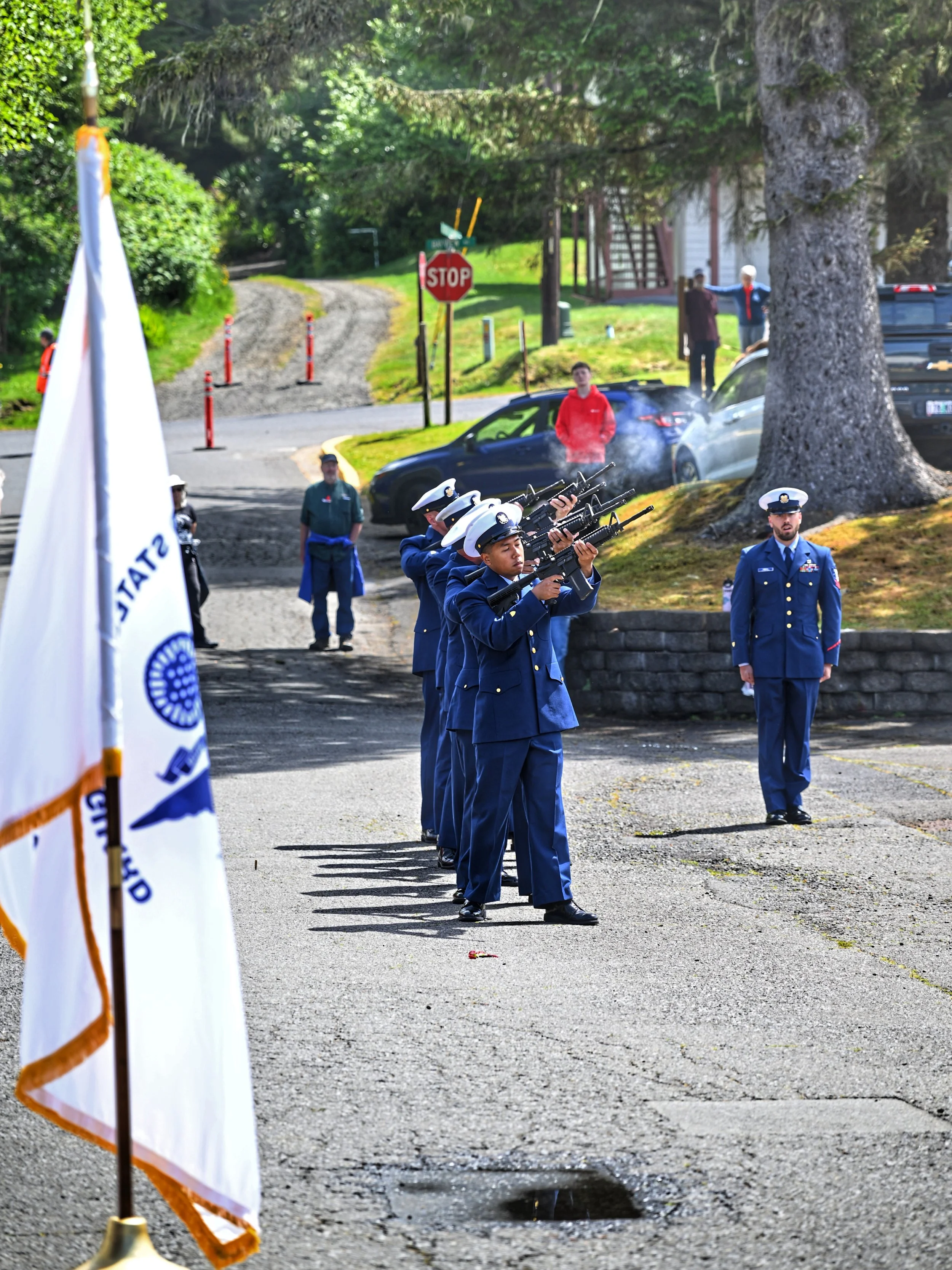 Three-volley rifle salute by the Coast Guard honor guard at the Depoe Bay harbor.