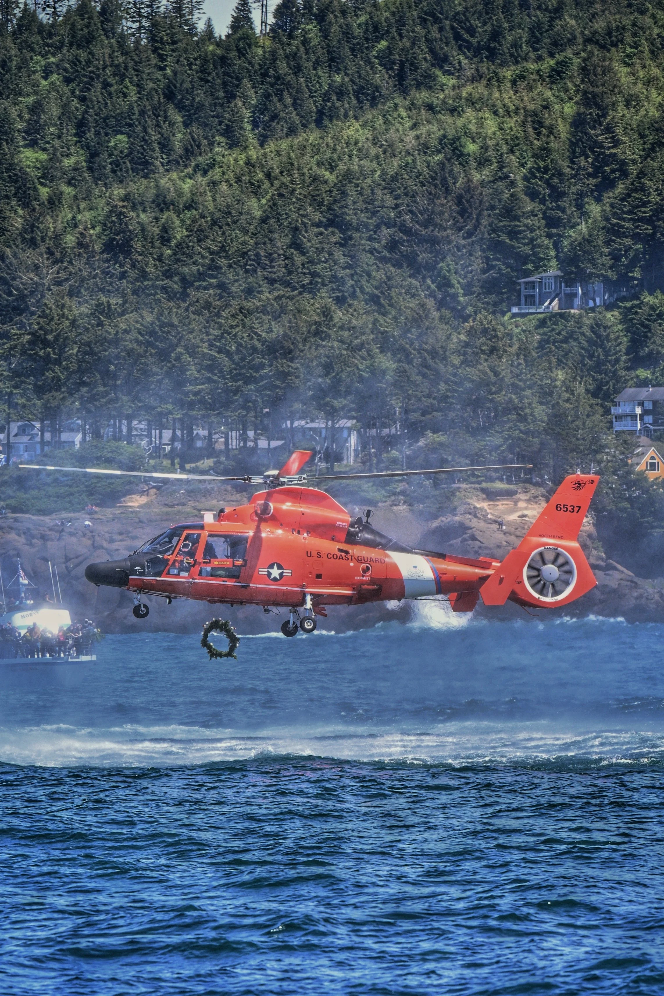 A helicopter dropping a wreath at Fleet of flowers in Depoe Bay, Oregon