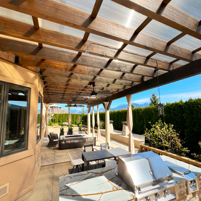 Outdoor pergola with roof panels creating a shaded and weather-protected seating area