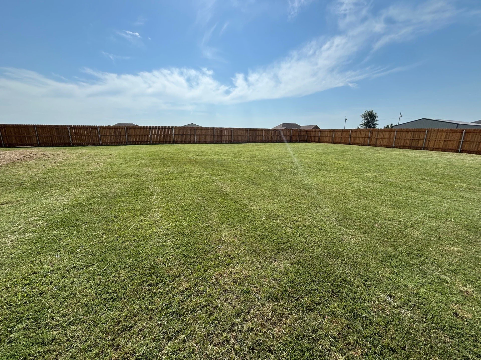 Overgrown lawn cleanup in Cushing, Oklahoma, with one-time mowing service to restore a large residential yard after vacation.