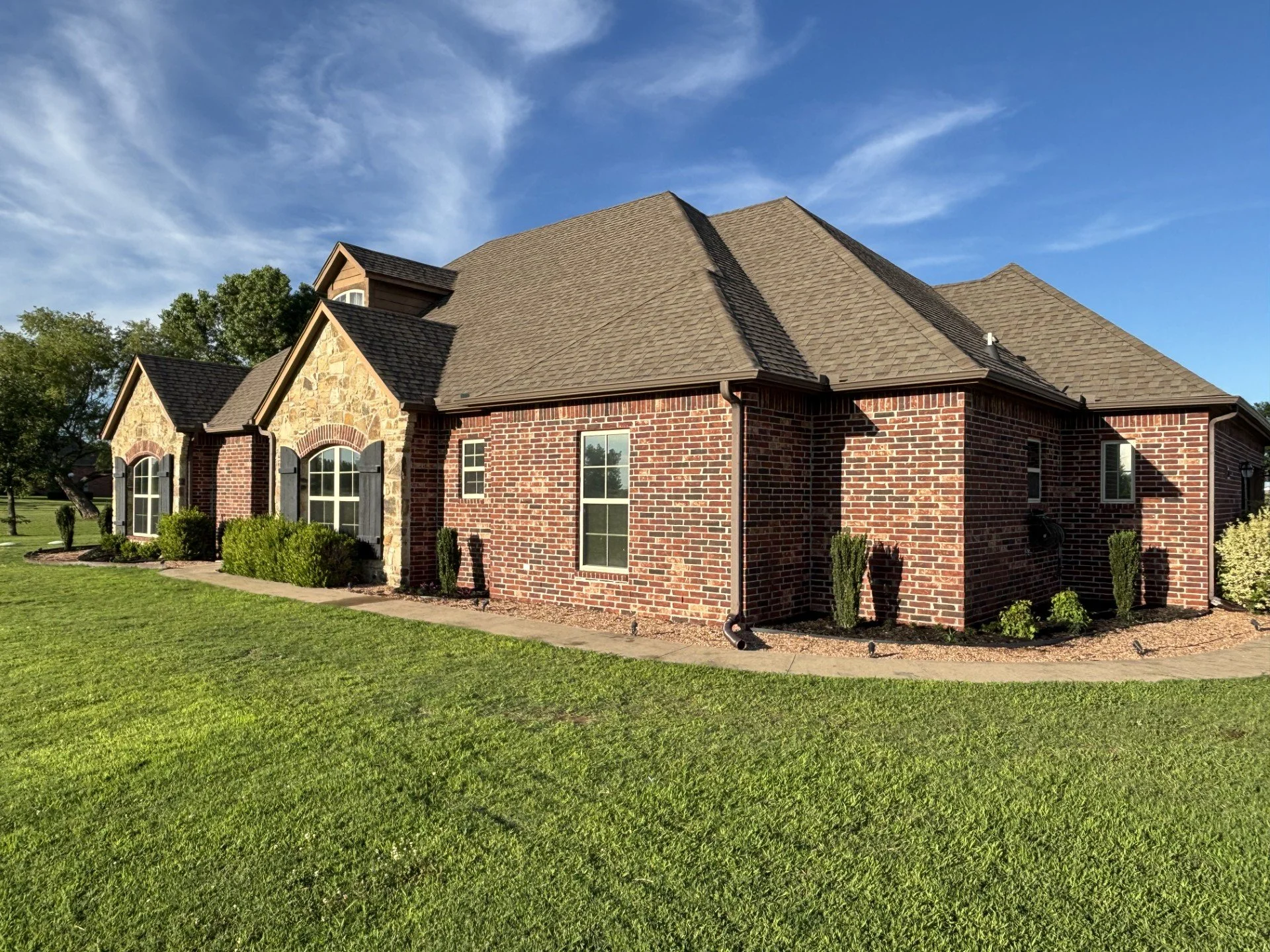 New landscape plant installation and fresh mulch completed in Stroud, Oklahoma to clean up the beds and add strong year-round curb appeal.