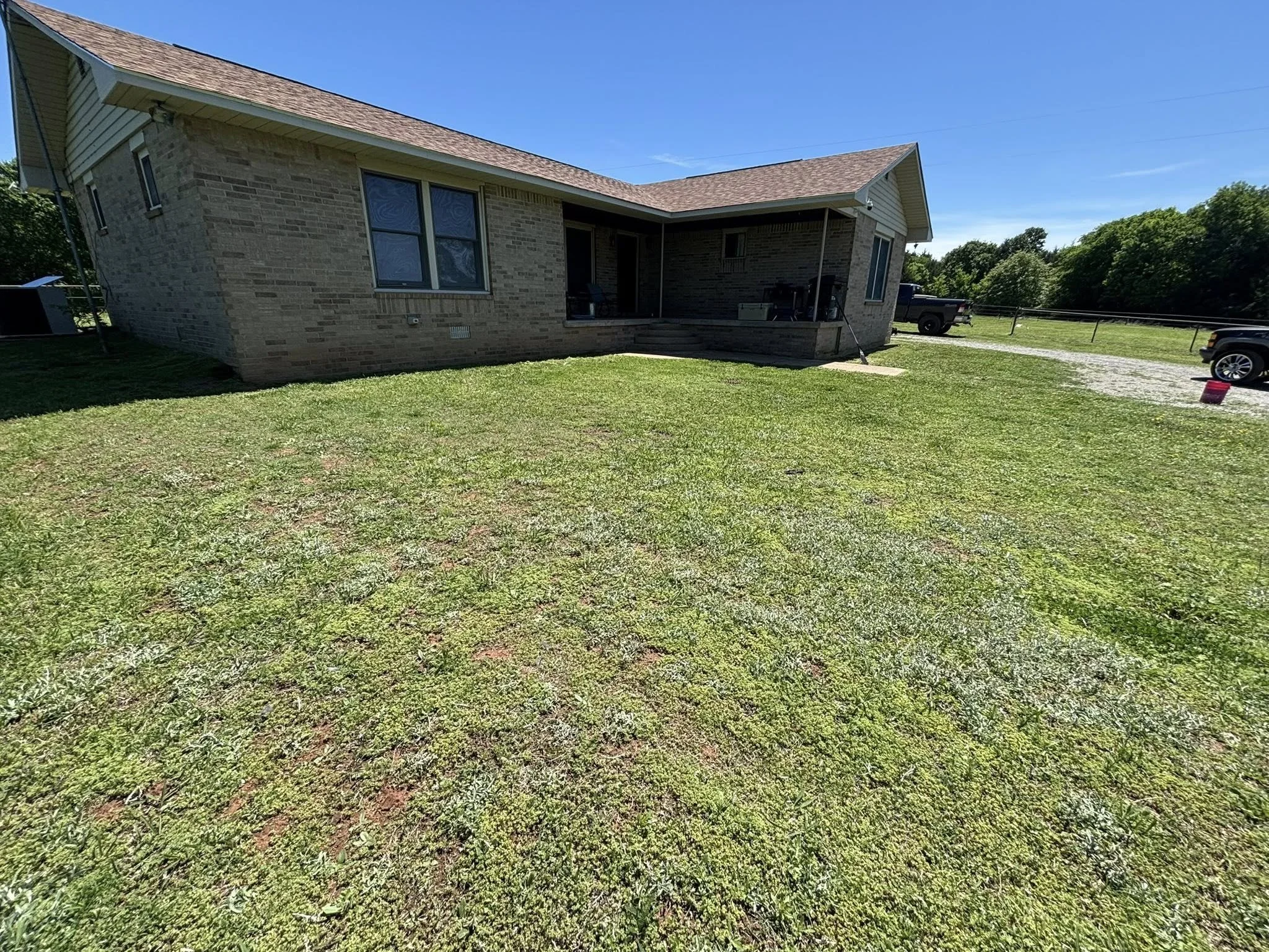Front lawn mowing service completed at the same Drumright property, providing a clean, even cut around the home and improving overall curb appeal.