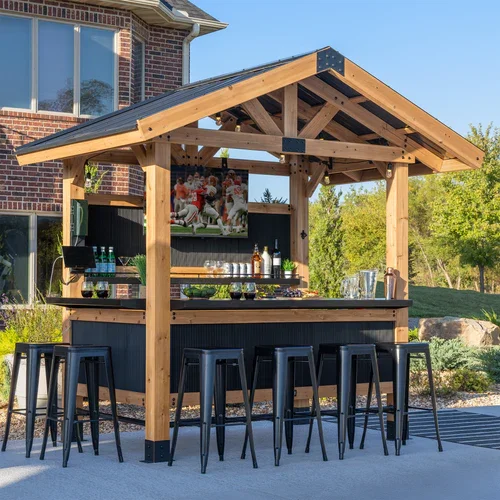 Backyard Discovery Palisade bar gazebo creating an outdoor entertainment space with bar seating, lighting, and TV in a residential backyard