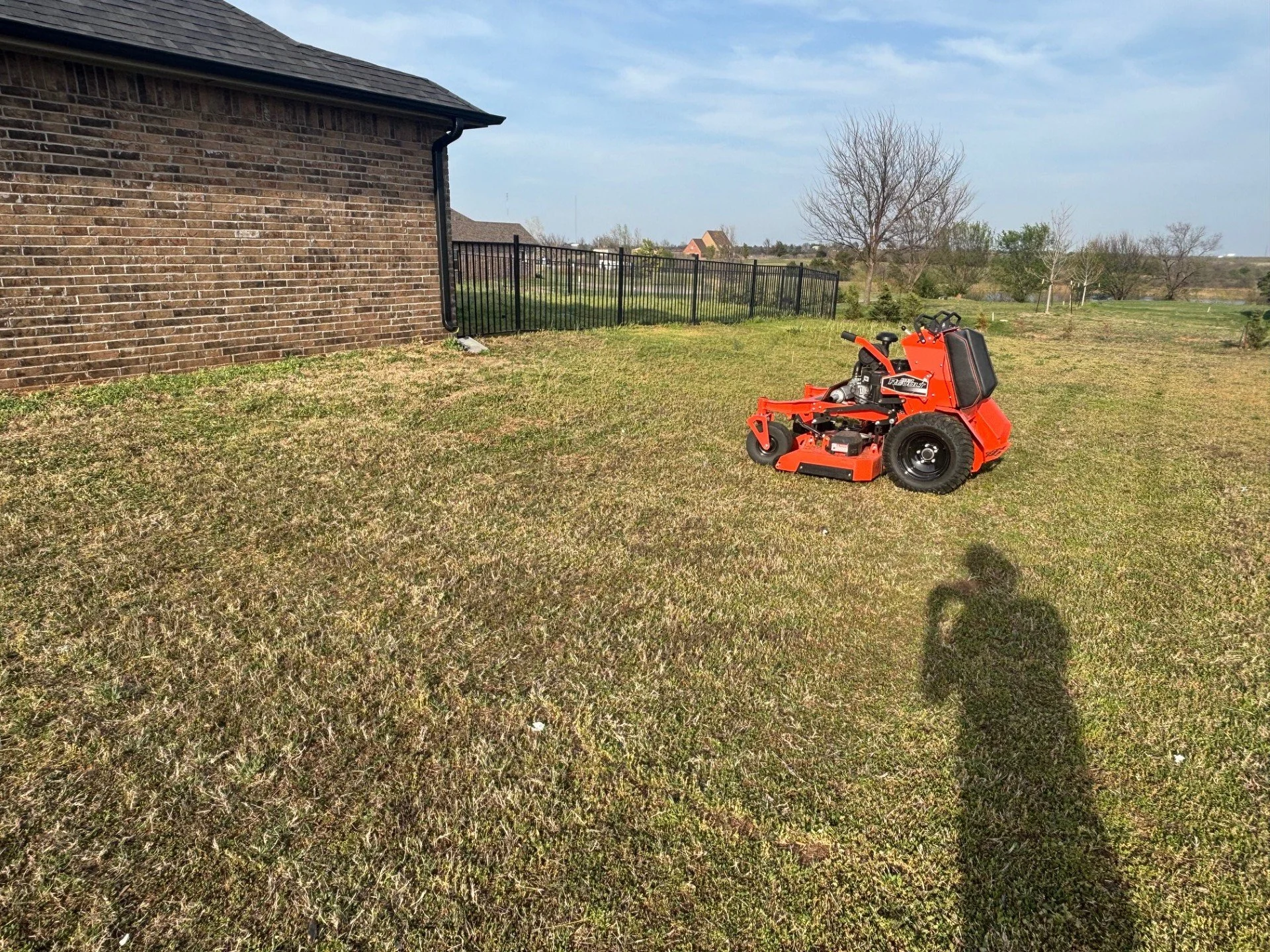 Biweekly lawn maintenance in Stillwater, Oklahoma – fenced residential yard serviced with mowing and dog waste removal