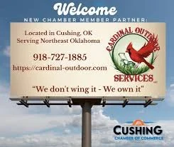 Billboard advertising Cardinal Outdoor Services, a roofing company in Cushing, Oklahoma, with contact info and slogan.
