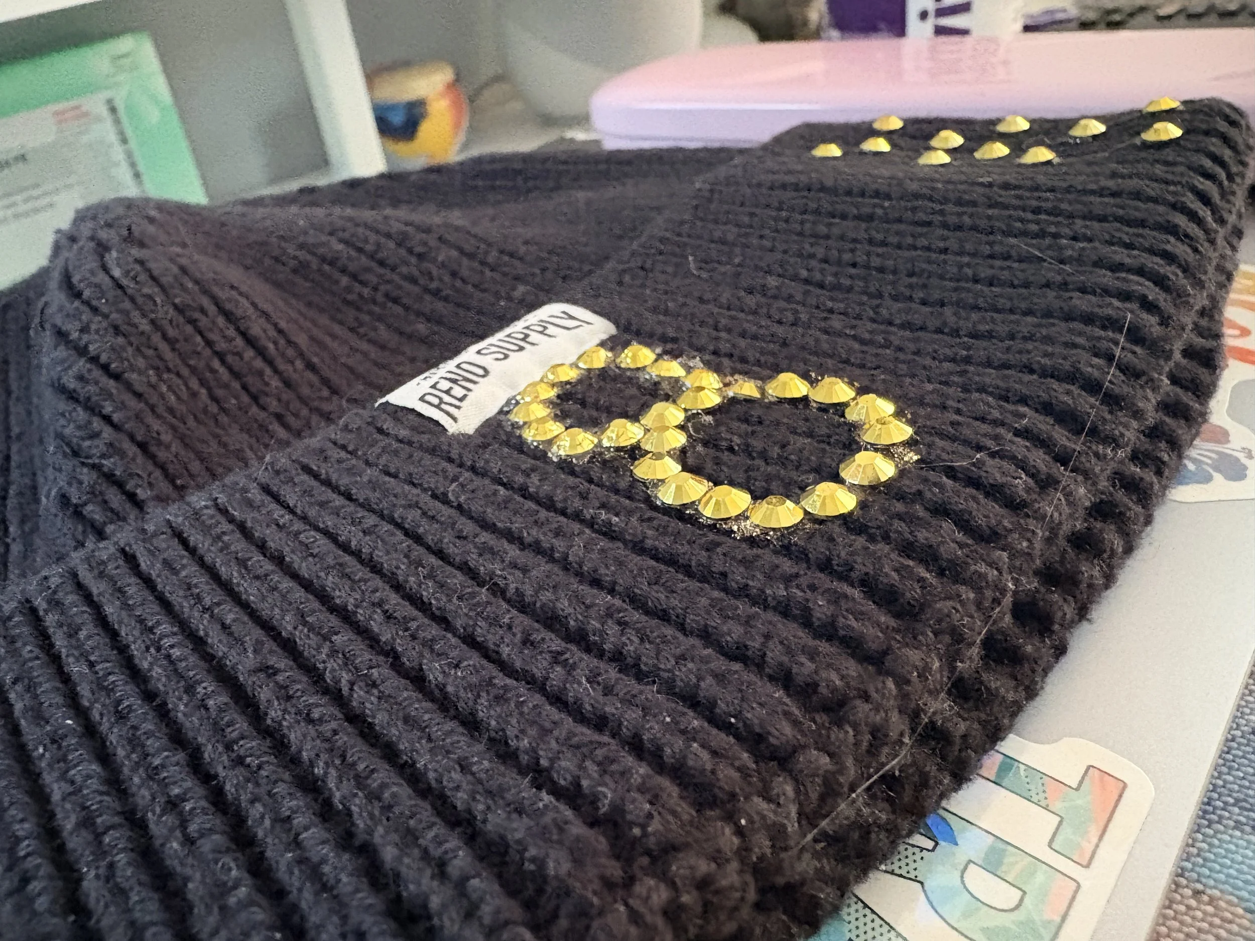 Black beanie with hand glued gems on top