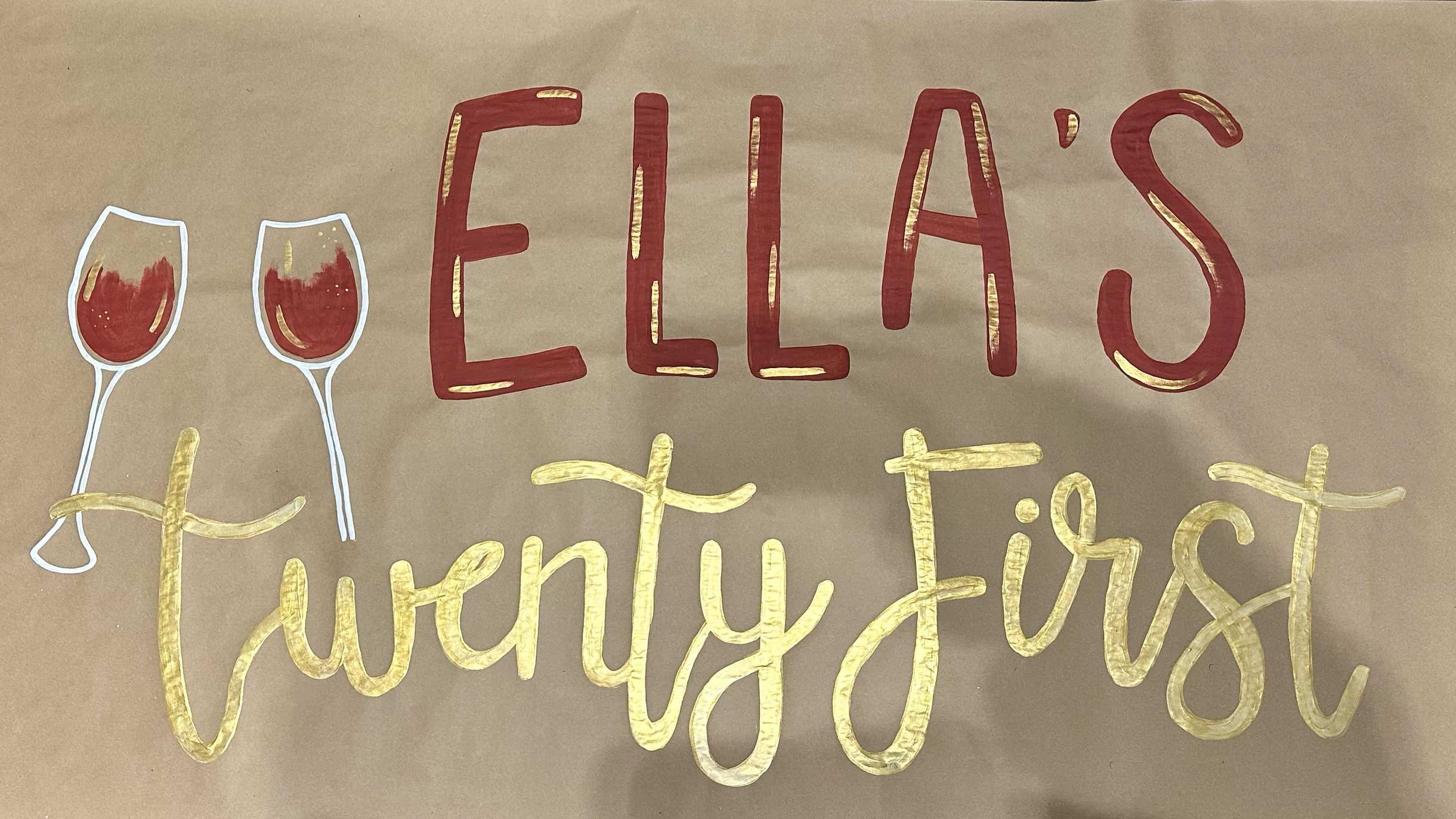 Decorative sign with the words "Ellas Thirty First" in red and gold lettering, featuring two drawn wine glasses filled with red wine.