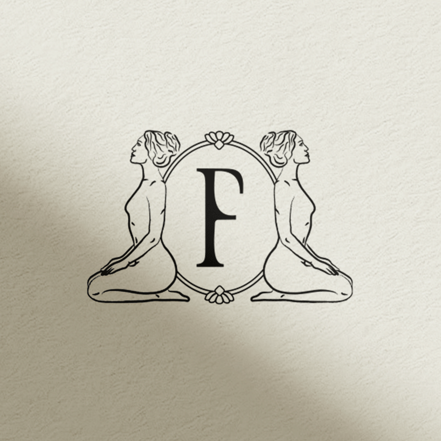 Decorative wall art featuring two mirrored women kneeling back-to-back with flowing hair, and a large letter 'F' in the center within an ornate floral frame.