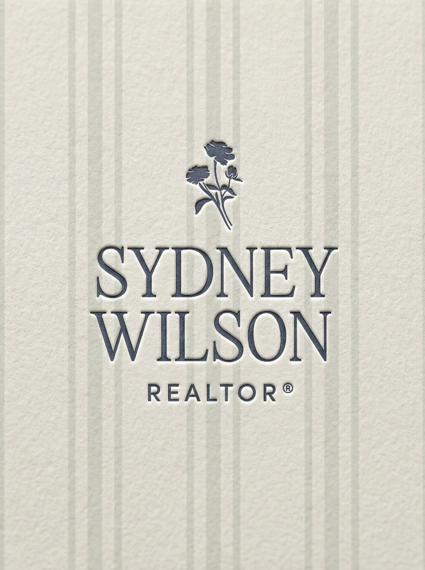 Business card or promotional material featuring the name Sydney Wilson, a realtor, with a logo of a plant above the name.