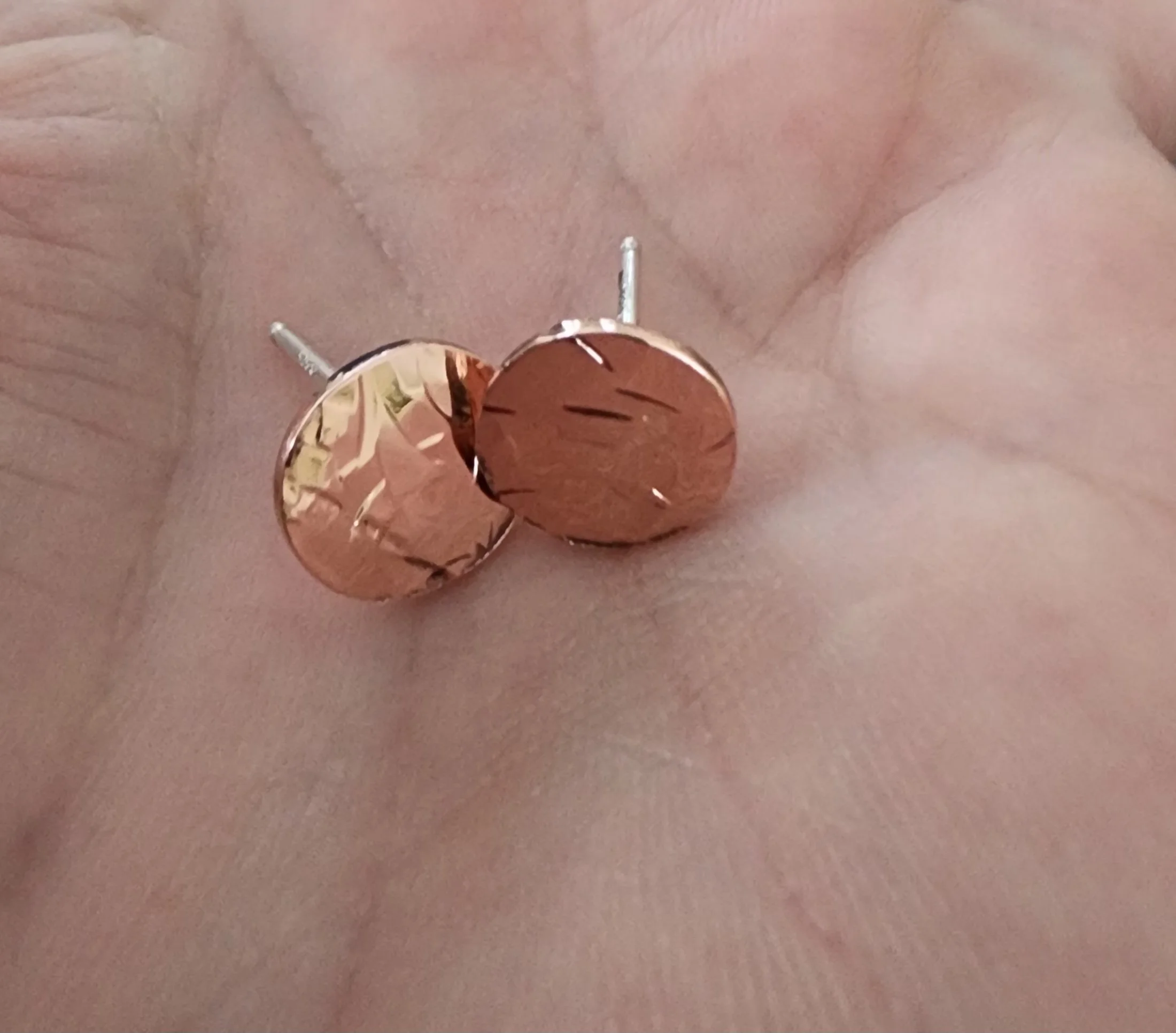 Copper shiny round textured earrings close up.jpg