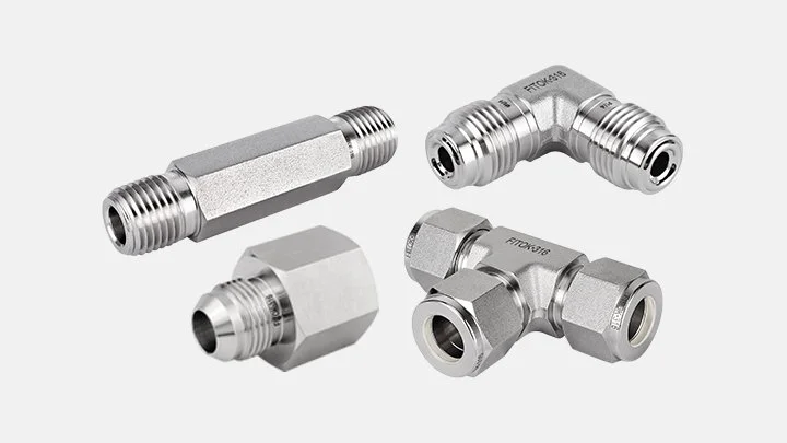 Four metal FITOK fittings for plumbing or gas lines, including a straight connector, a T-shaped connector, and a couple of elbow fittings.