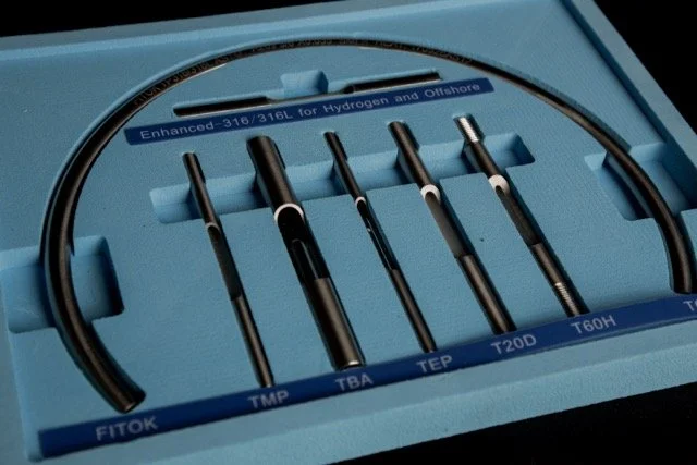 A set of five precision metal probes with black handles and metallic tips, arranged in foam cutouts labeled TFTOK, TPA, TEP, T20D, T60H, inside a blue protective case for hydrogen and offshore applications.