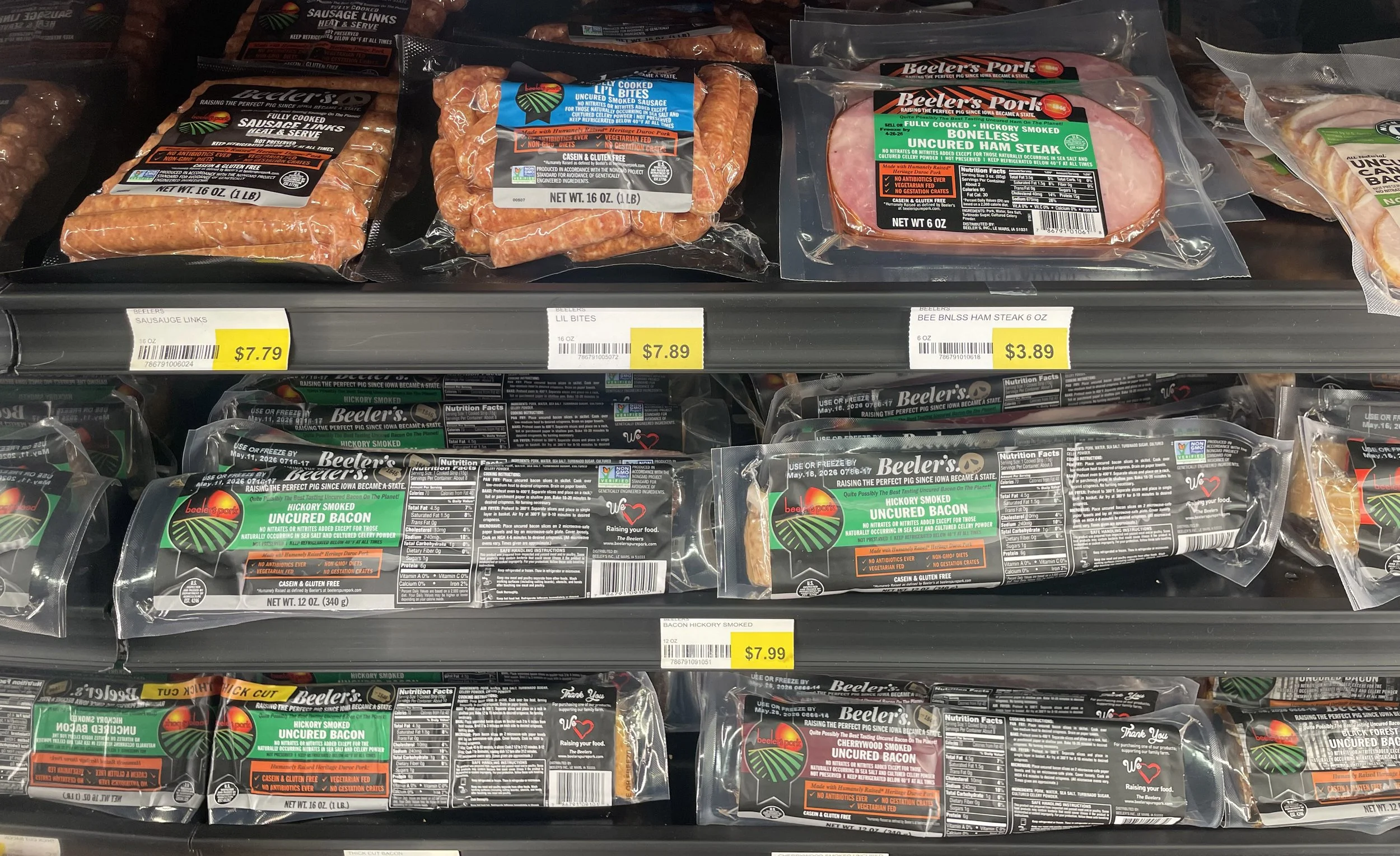 Prepackaged Beeler's uncured bacon, ham steak, and little sausages.
