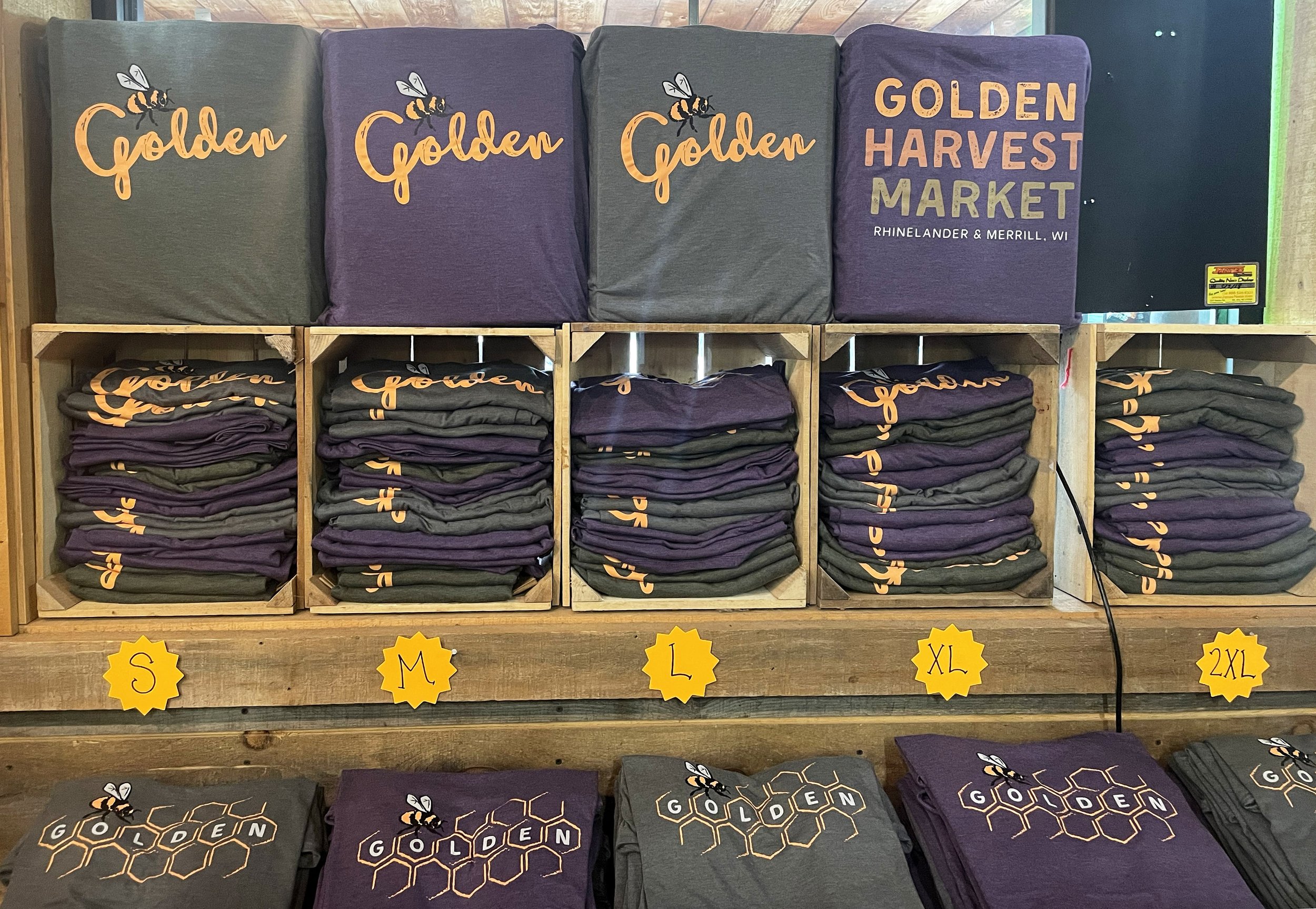 Golden Harvest t-shirt display featuring bee golden graphic.