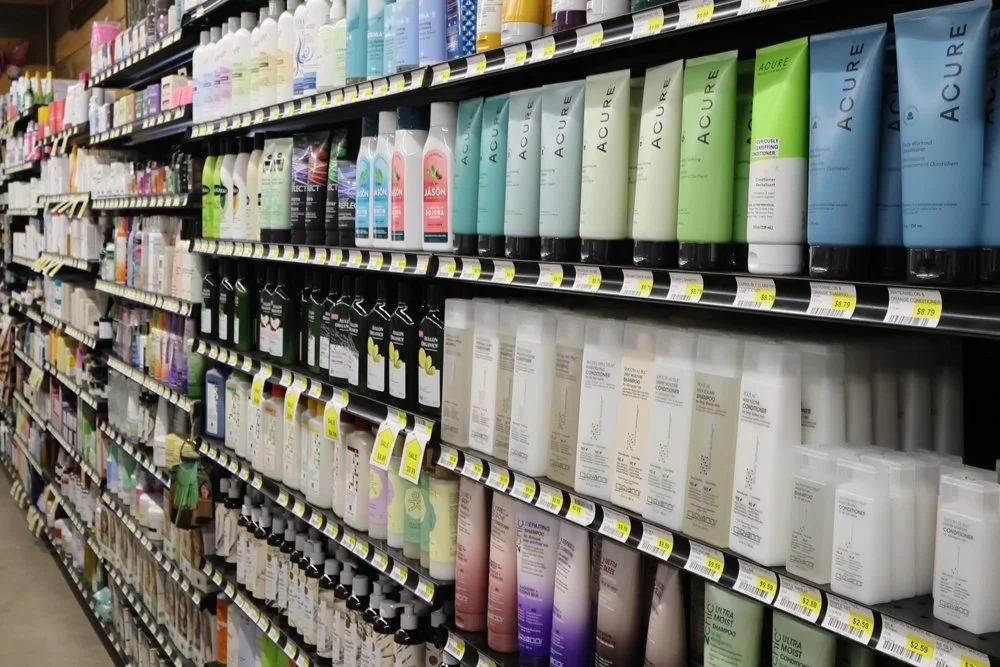 Aisle of skincare and body care products on store shelves.