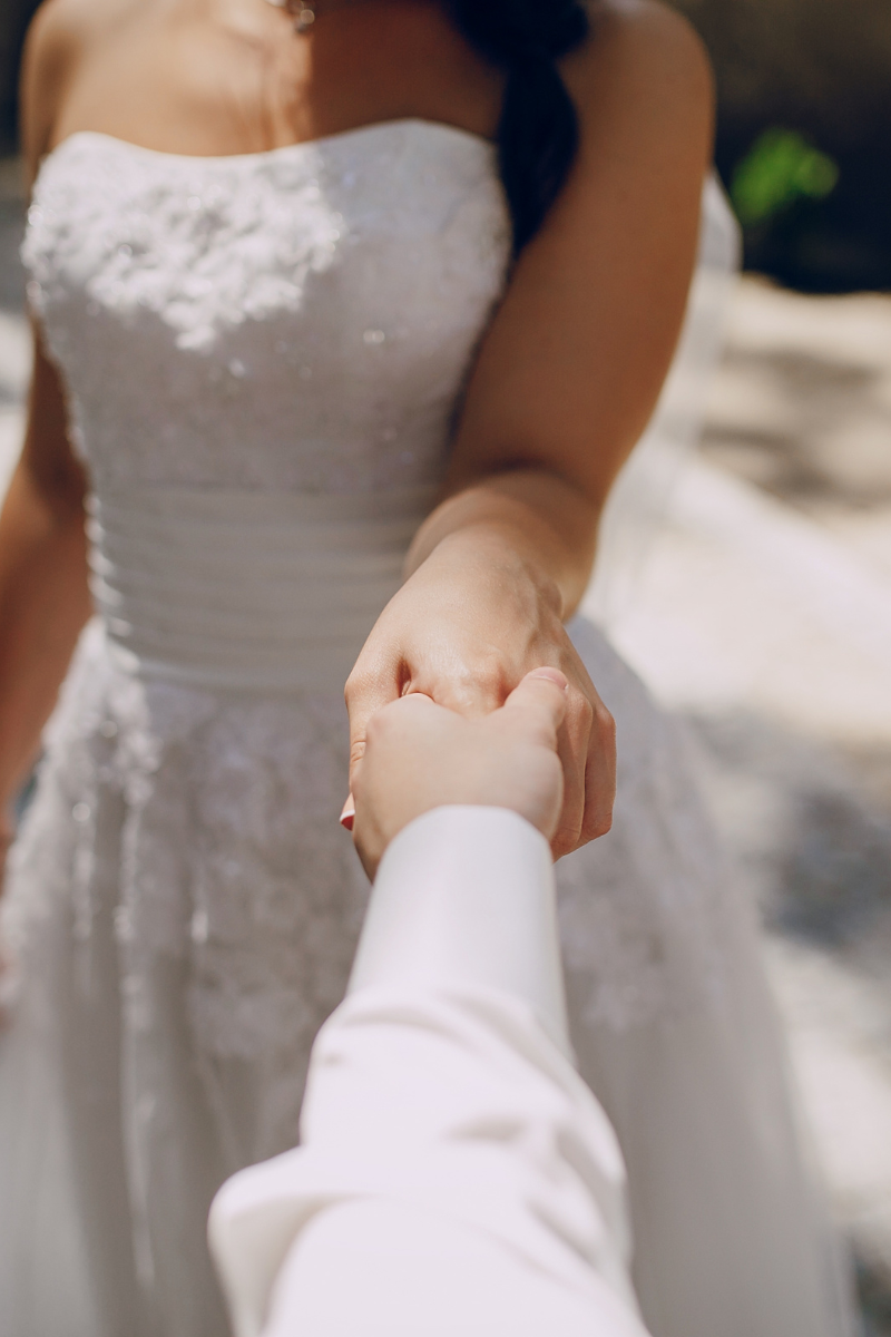 couple holding hands on their wedding day