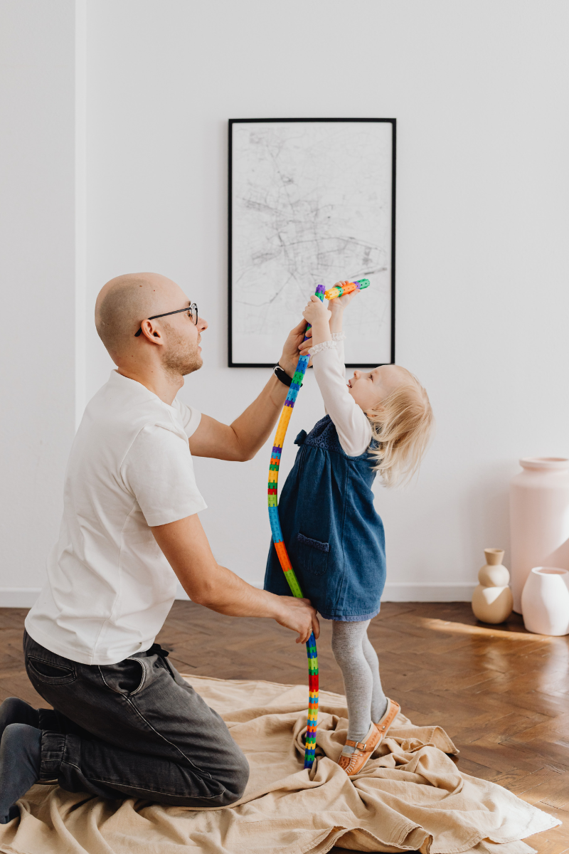 dad and daughter playing with toys