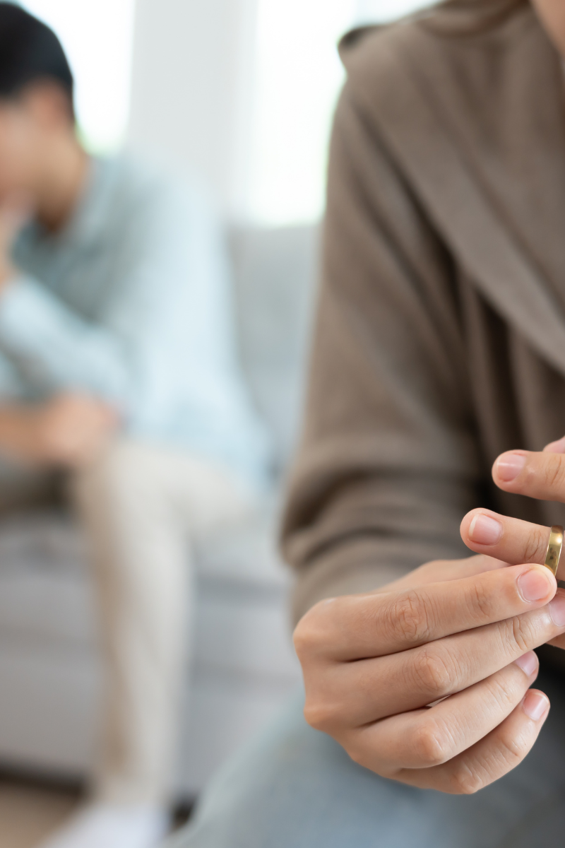 person taking off her wedding ring