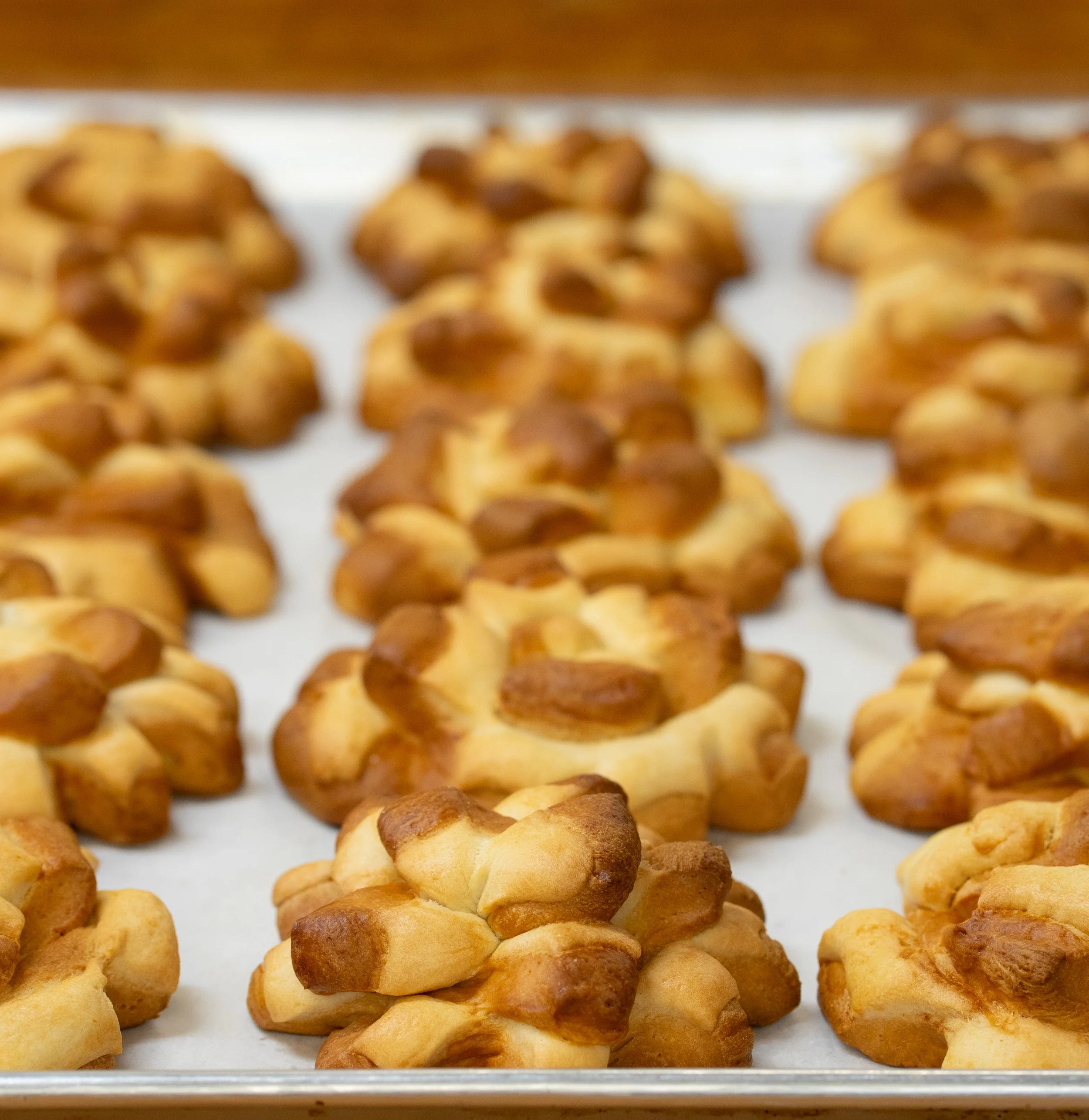 Baked cluster cookies with a golden-brown exterior on a baking sheet.