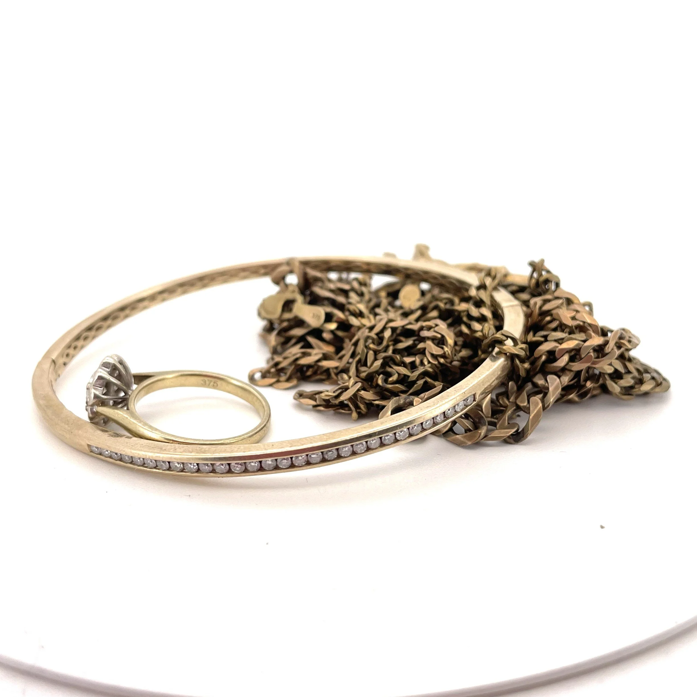 Client-supplied gold and diamond jewellery before being transformed into a snake cuff