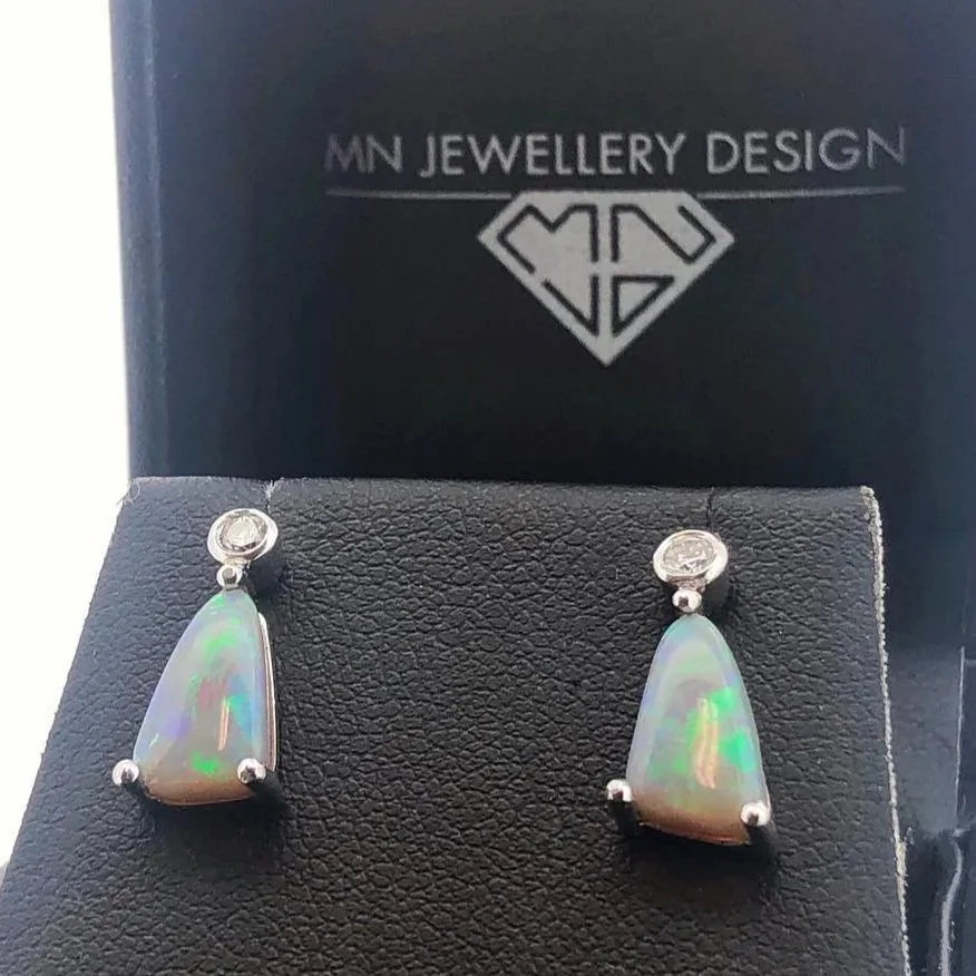 Opal drop earrings in a black display box with 'MN JEWELLERY DESIGN' logo.