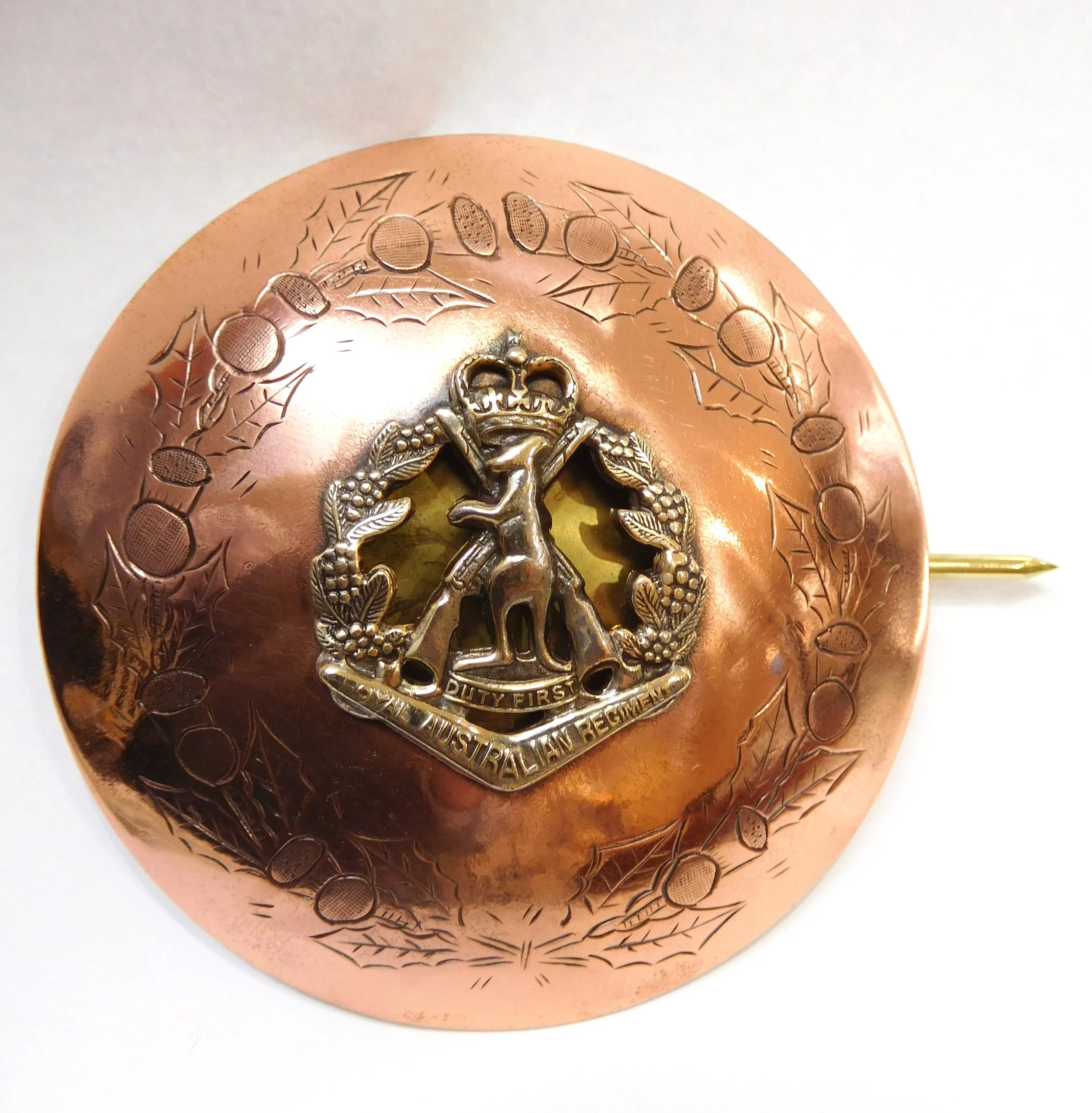 A copper commemorative military pin 