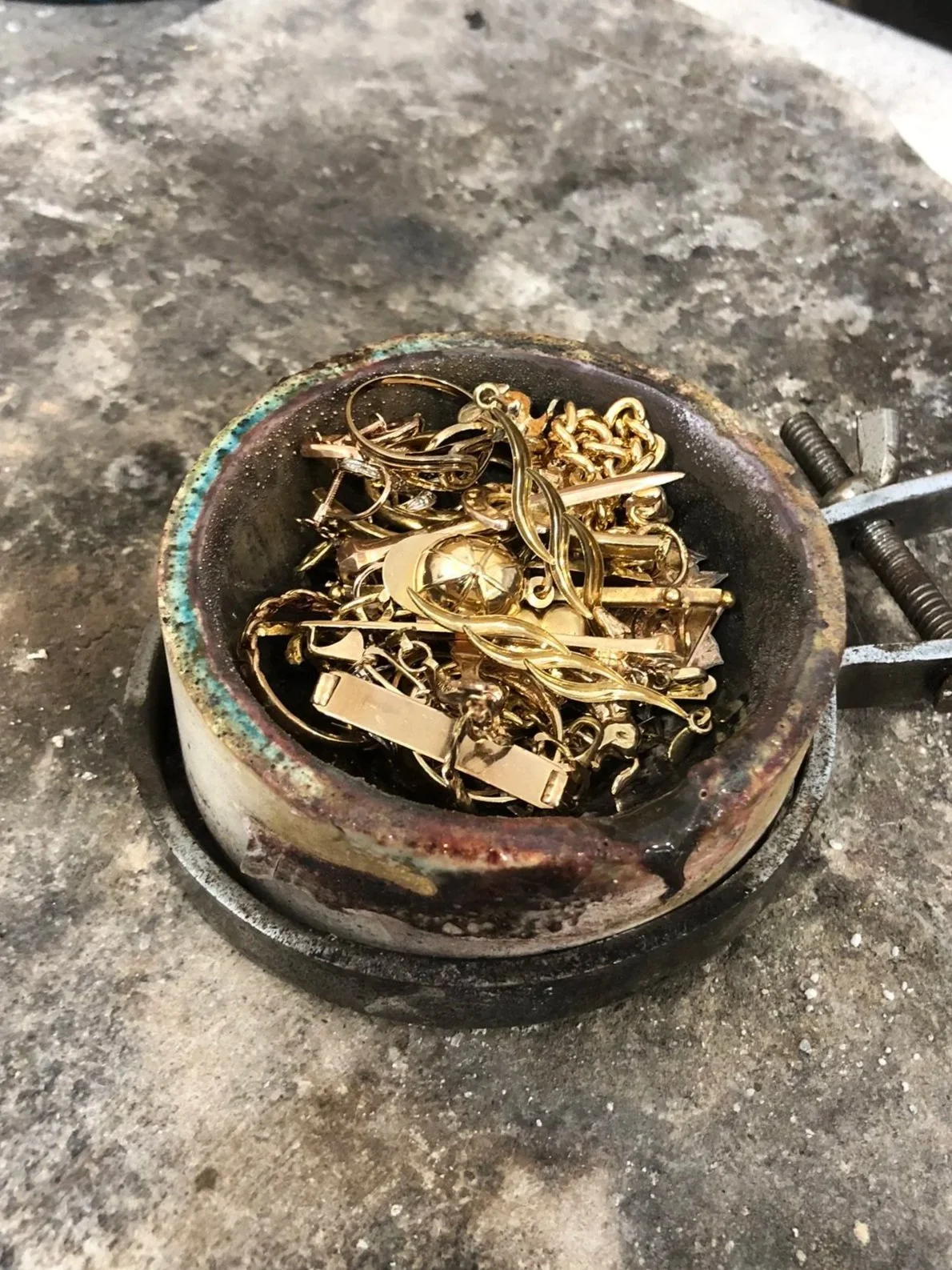 Old gold jewellery before being recycled into a hinged bangle