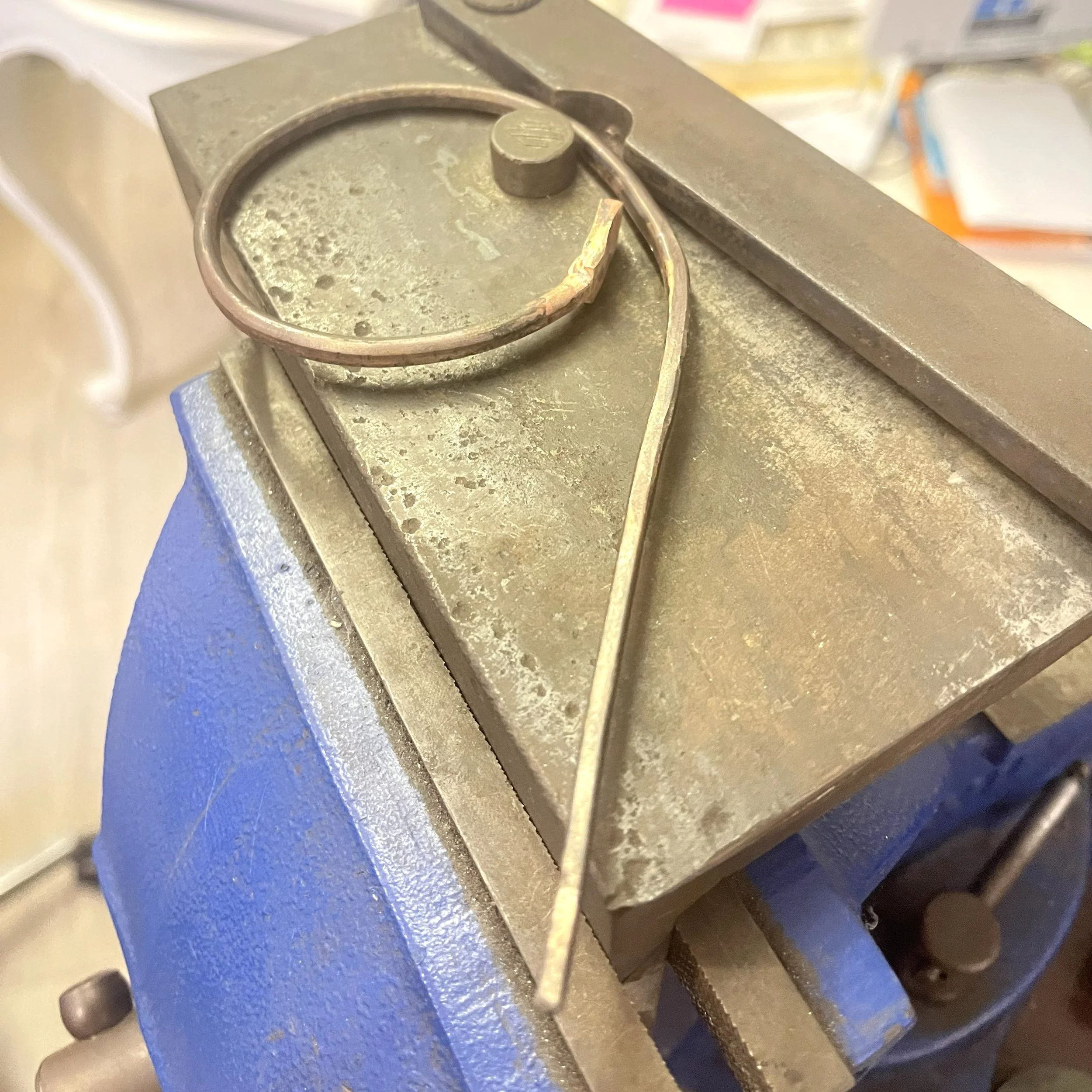 Gold cuff being shaped by hand during snake cuff fabrication