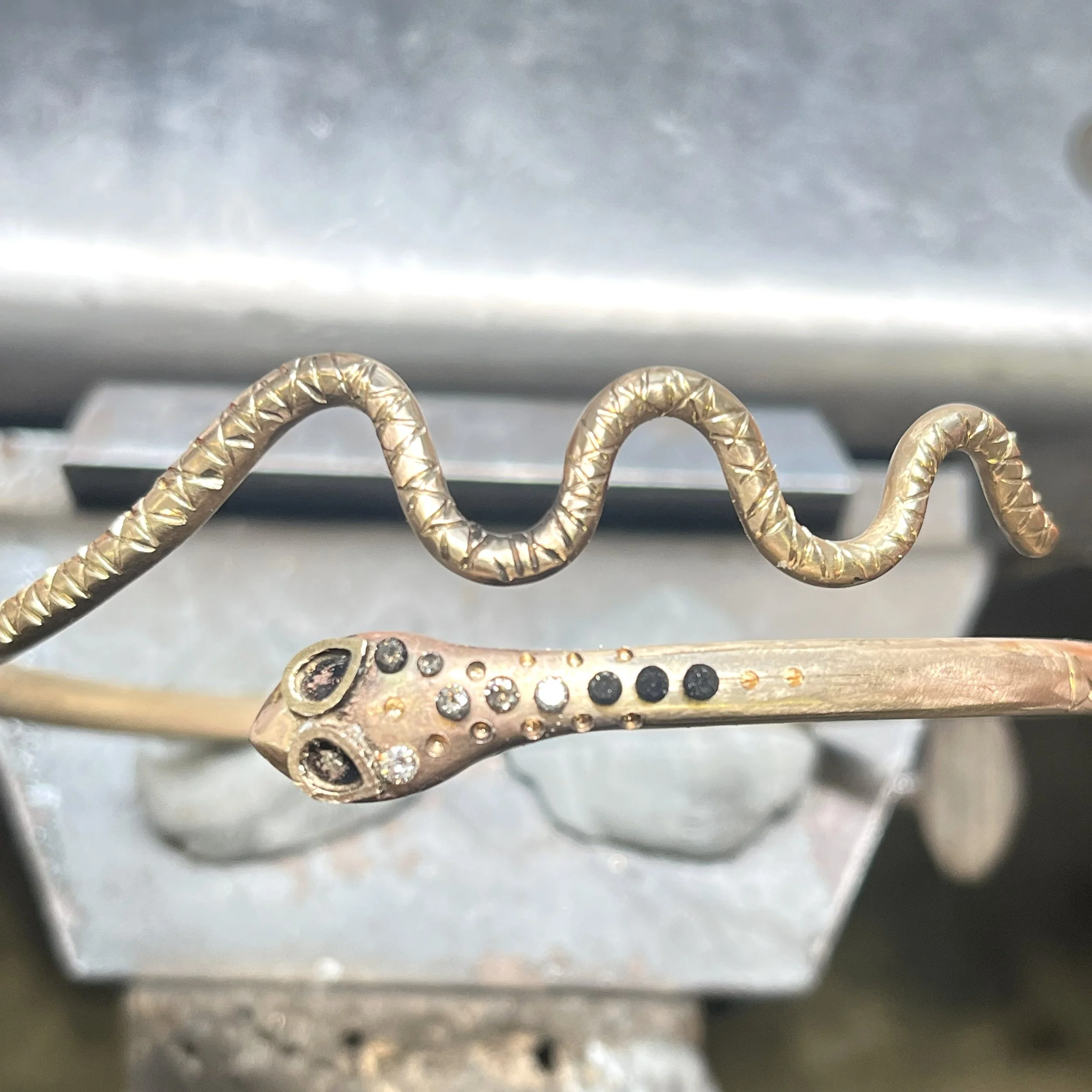 Hand-engraved snake cuff in progress before final finishing