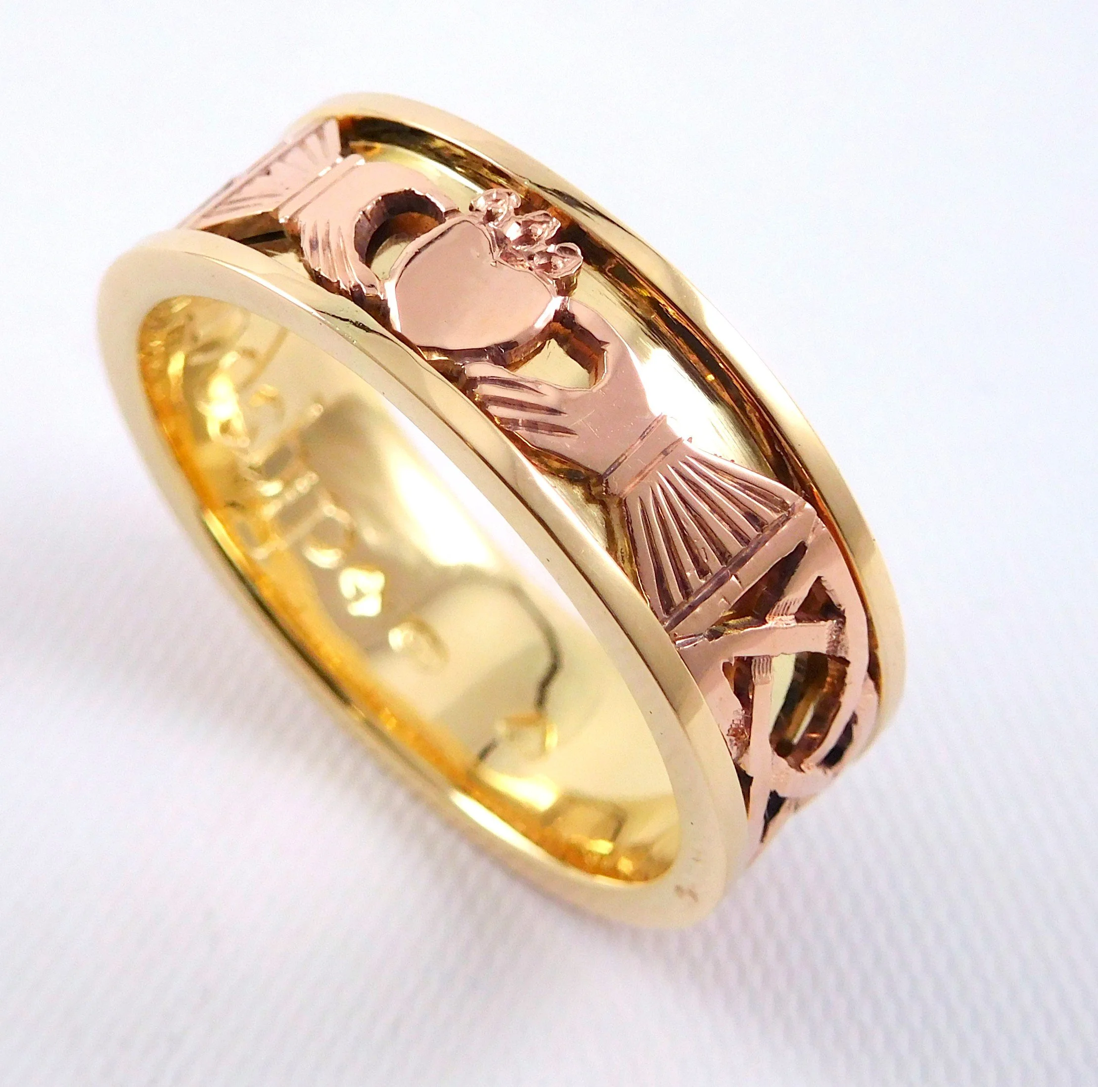 A close-up image of a gold and rose gold ring with a celtic design.