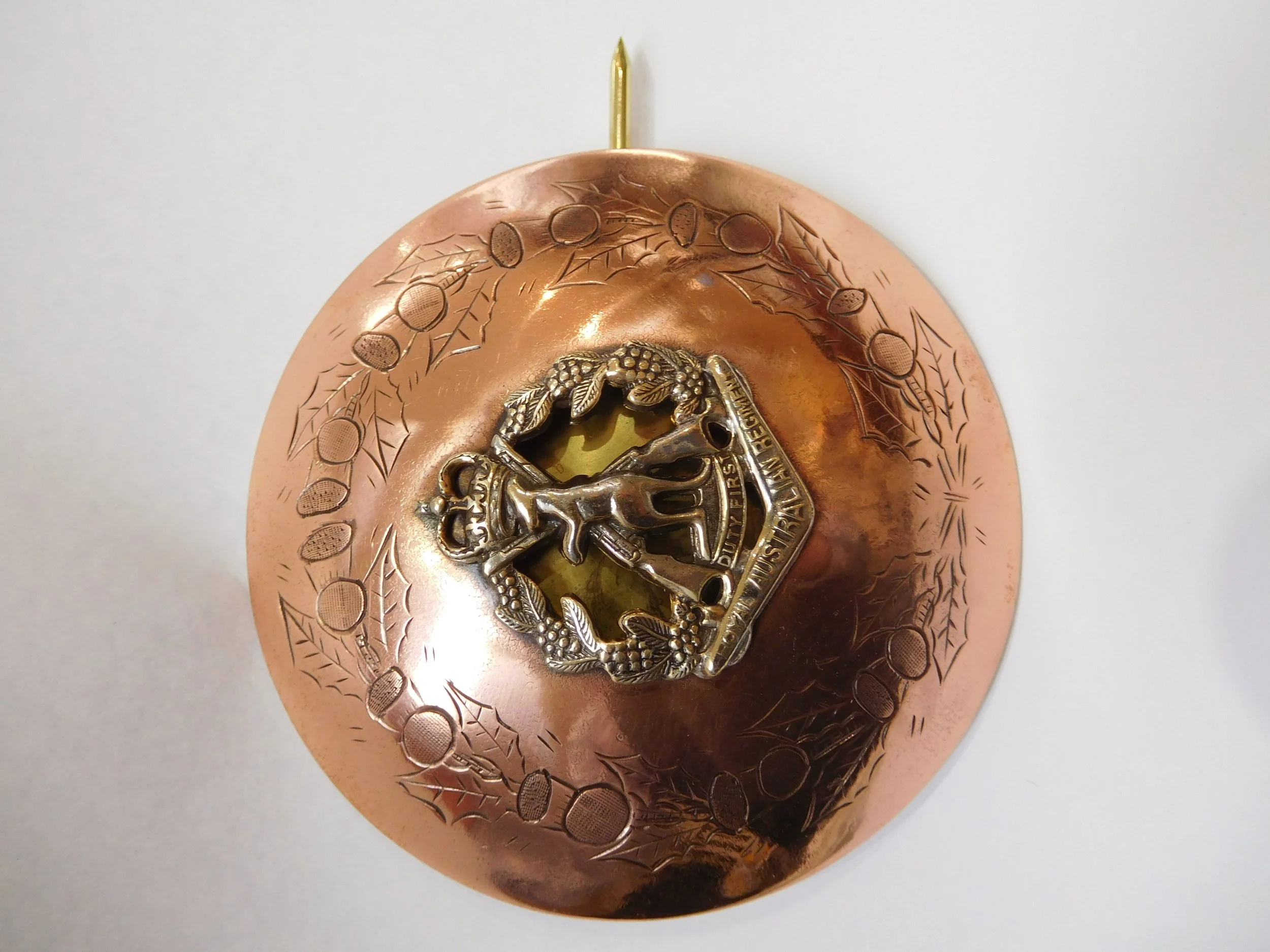 A copper military kilt pin.
