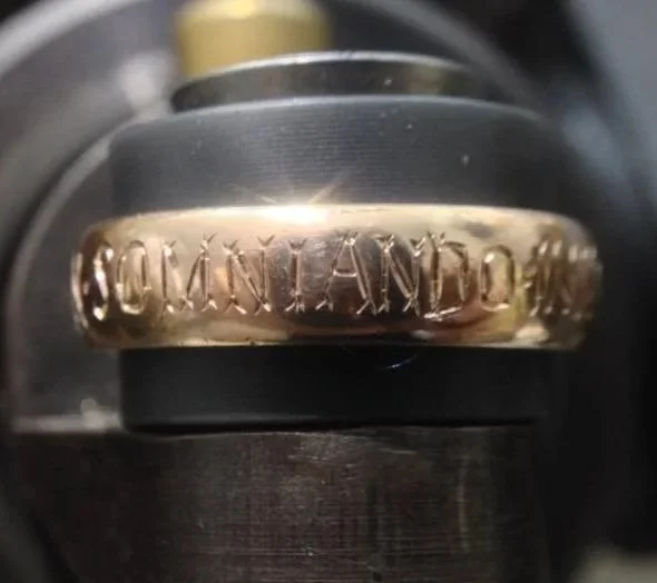 Close-up of a metal ring engraved .