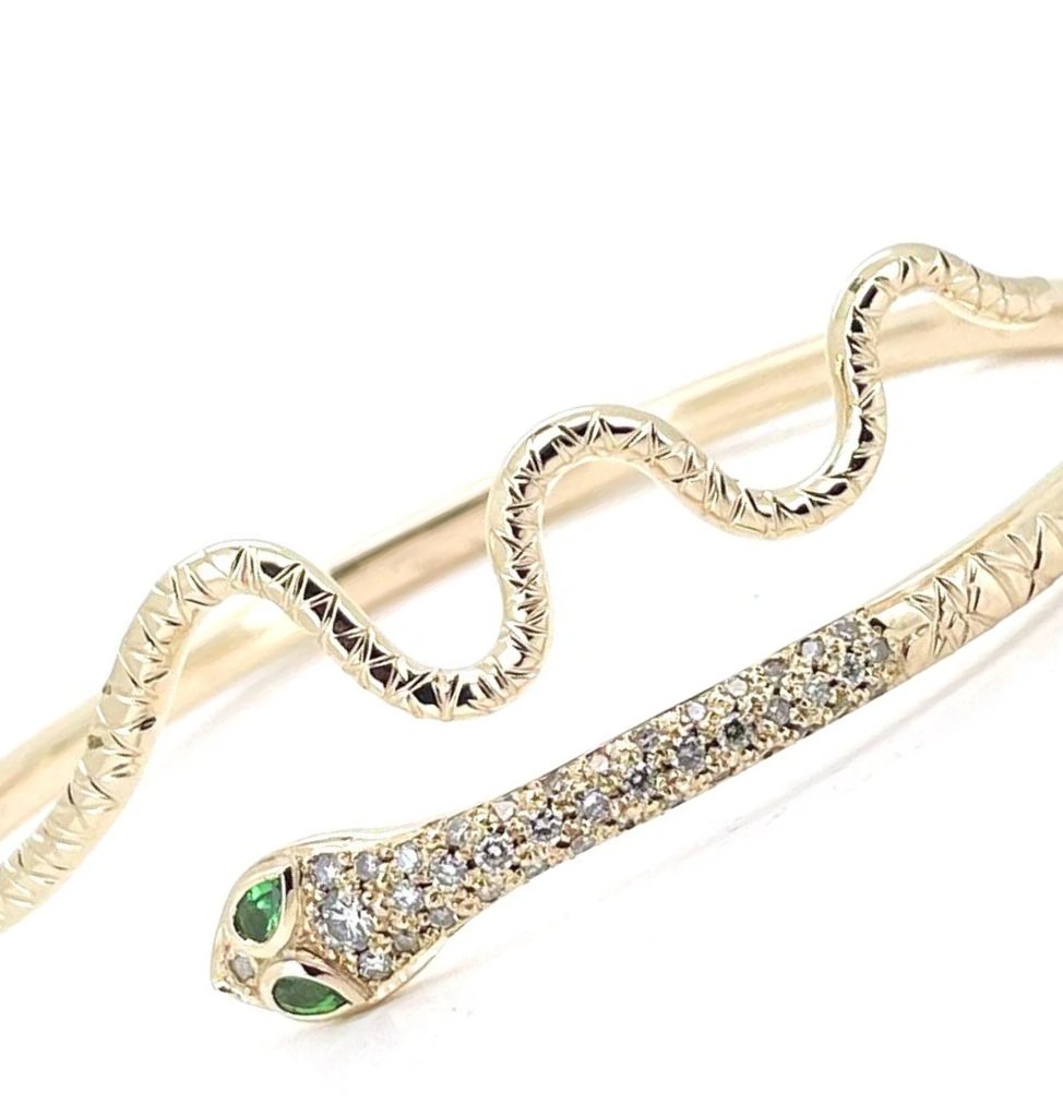 Old gold and diamonds transformed into a handmade snake cuff with emerald eyes