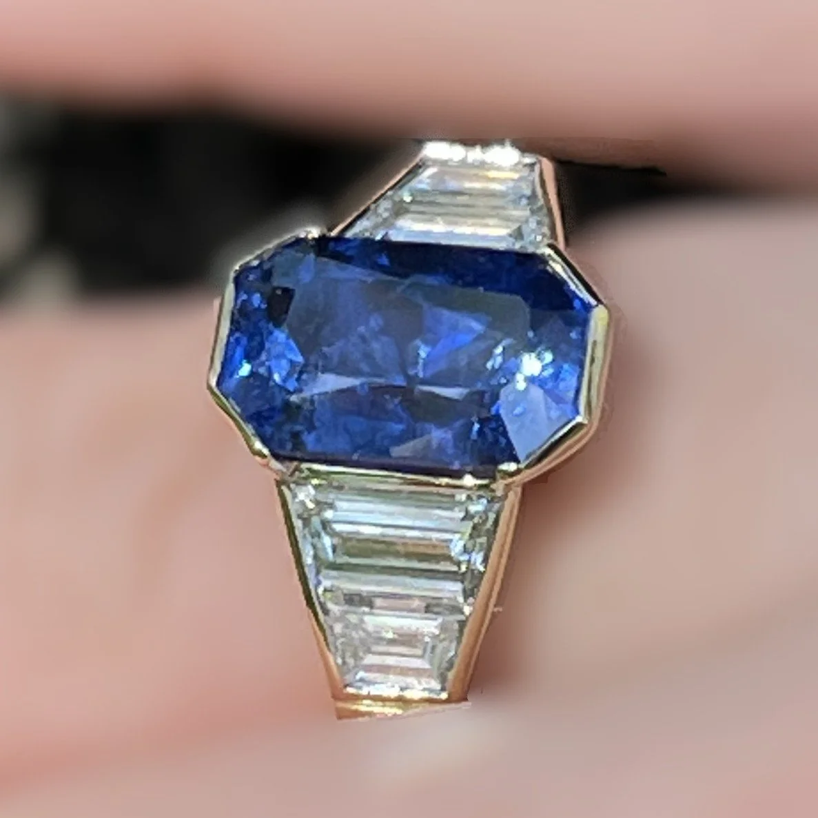 Bespoke sapphire engagement ring with trapeze diamond side stones